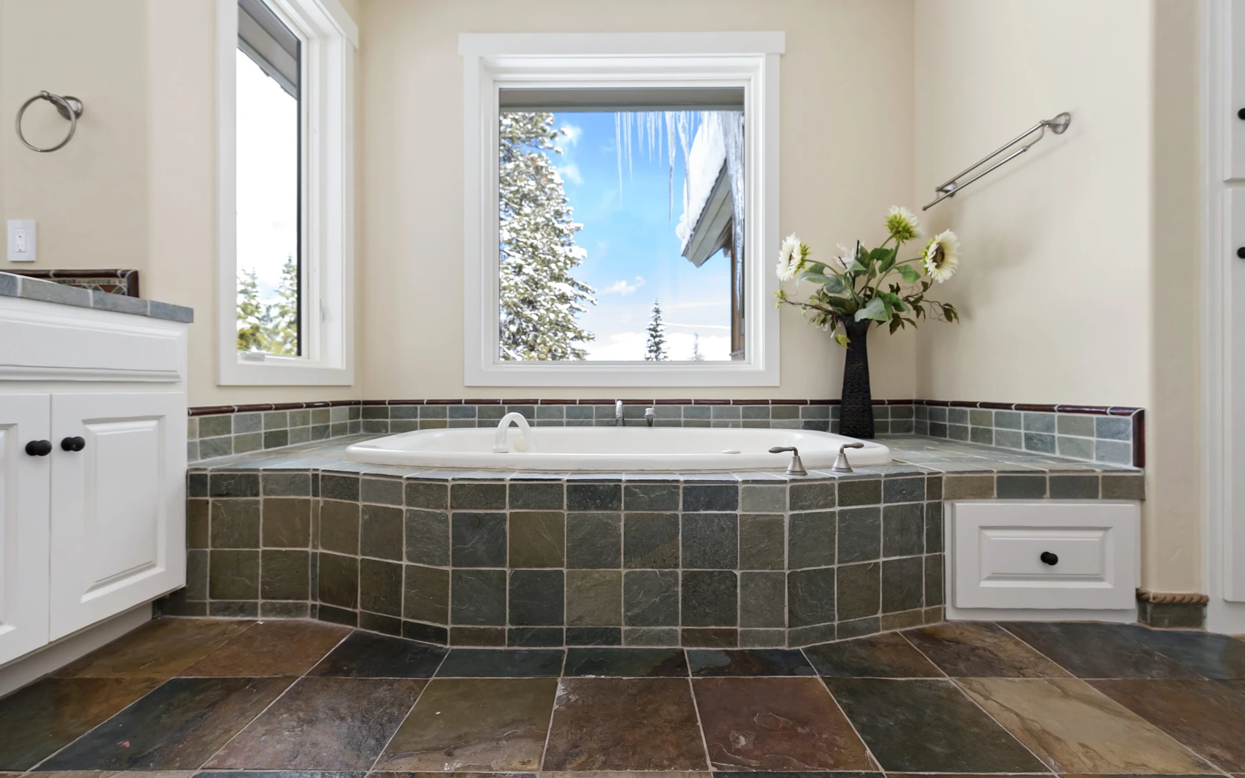 Bathroom in the Club Hill Refresh remodel at Whitetail Club, with a soaking tub, wood cabinetry, and natural light.