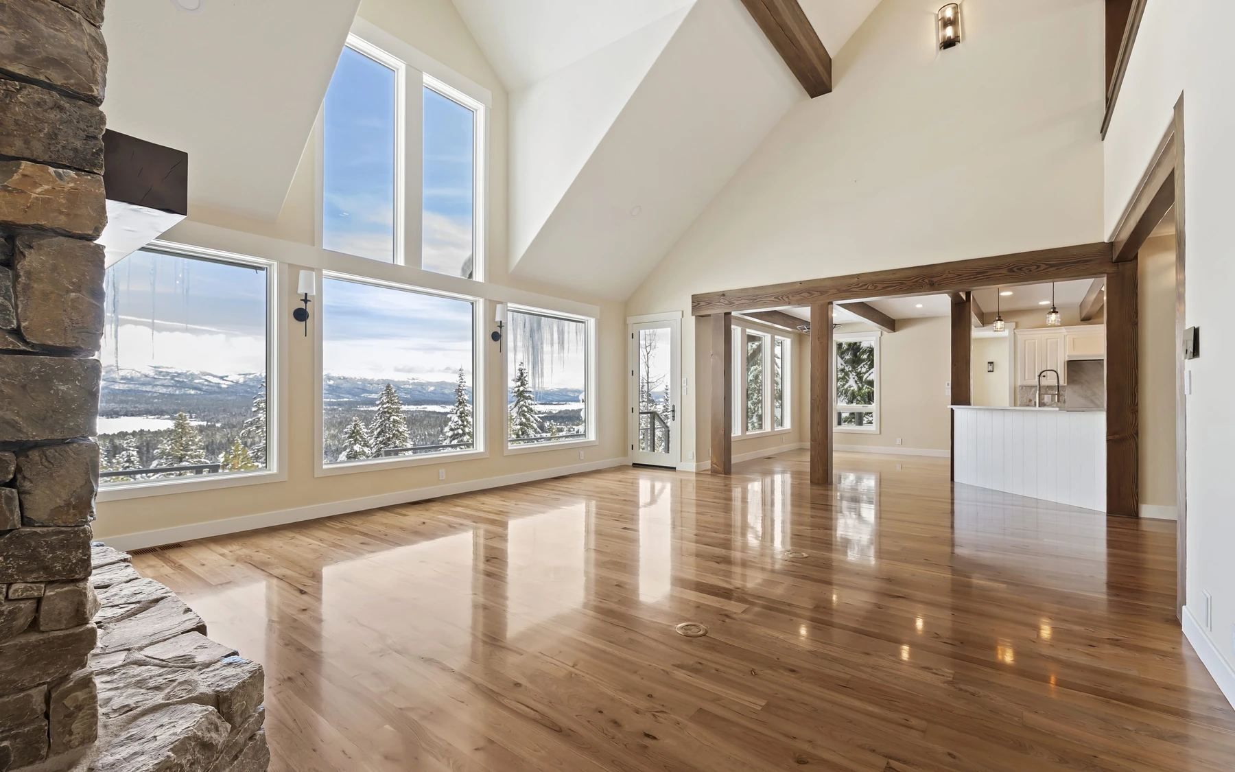 Interior detail in the Club Hill Refresh remodel at Whitetail Club, showing large windows, wood finishes, and stone details.