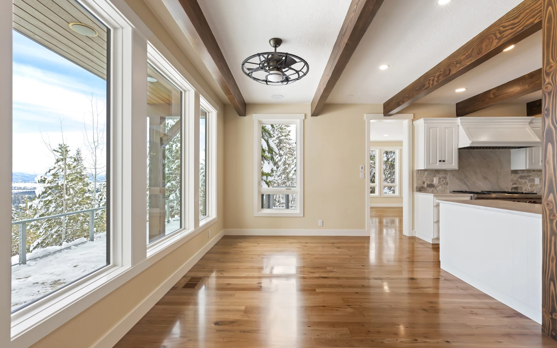 Exterior of the Club Hill Refresh remodel at Whitetail Club, showing wood siding and timber details and large windows.
