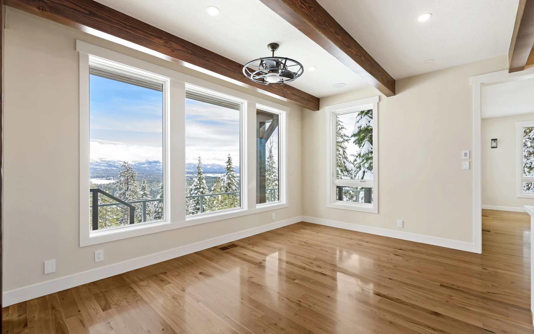 Exterior of the Club Hill Refresh remodel at Whitetail Club, showing wood siding and timber details and large windows.