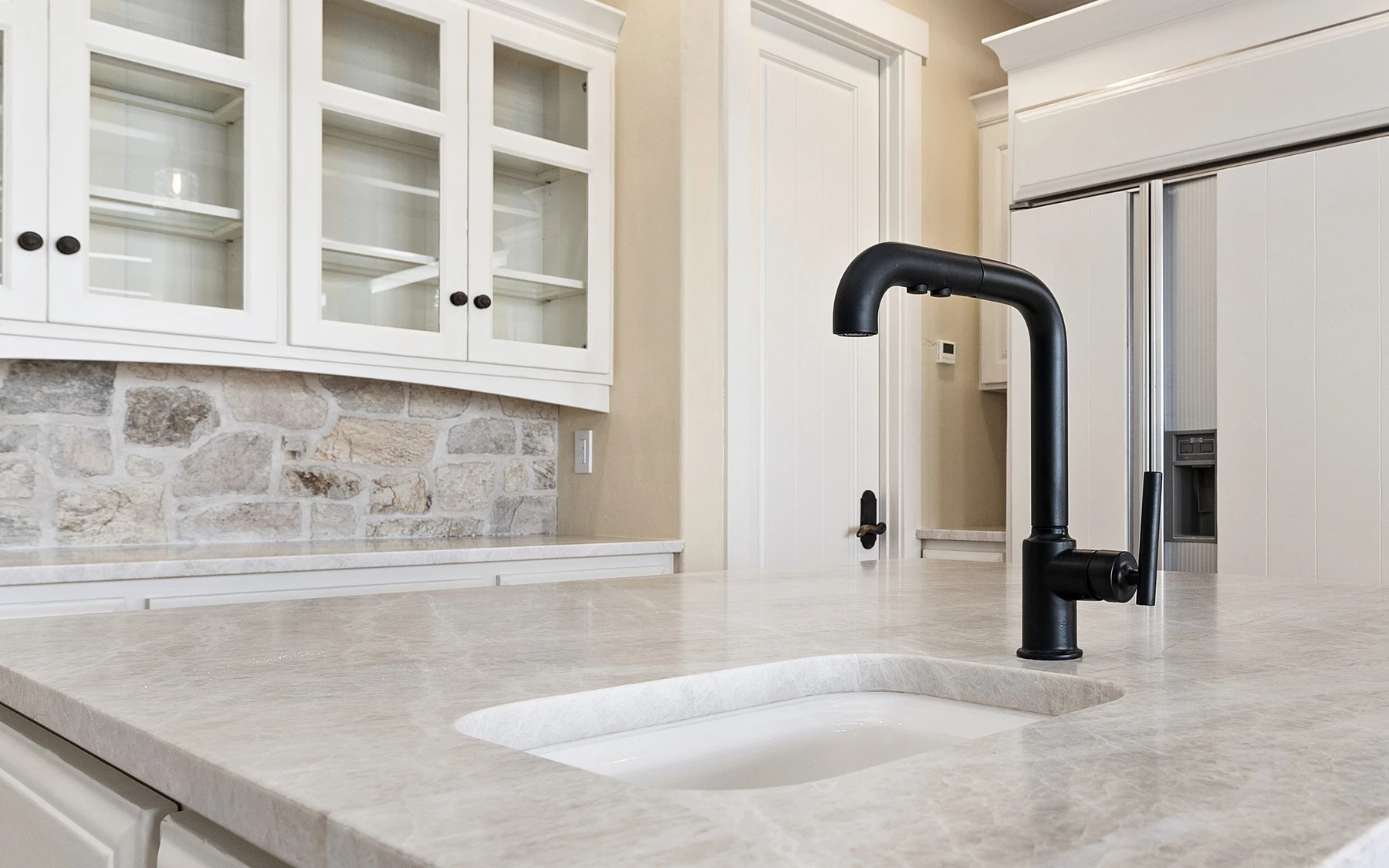 Kitchen in the Club Hill Refresh remodel at Whitetail Club, with wood cabinetry.
