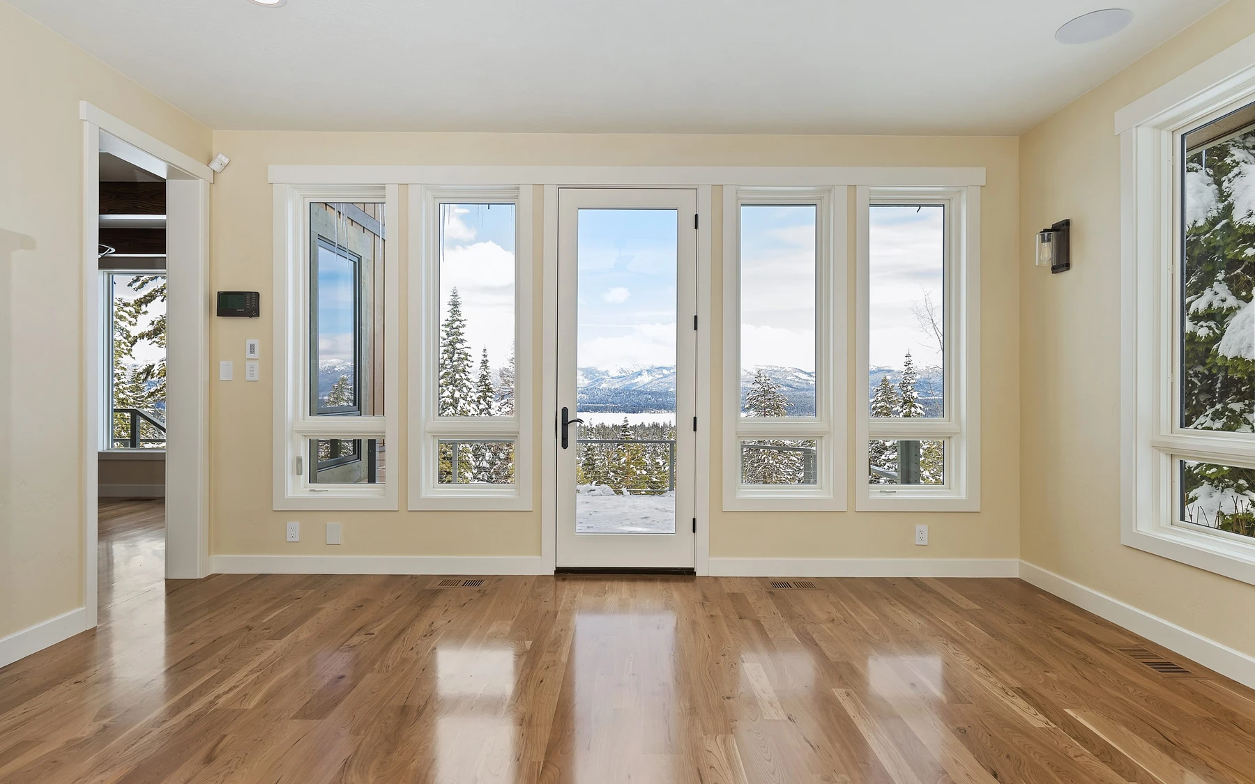 Interior detail in the Club Hill Refresh remodel at Whitetail Club, showing large windows and wood finishes.