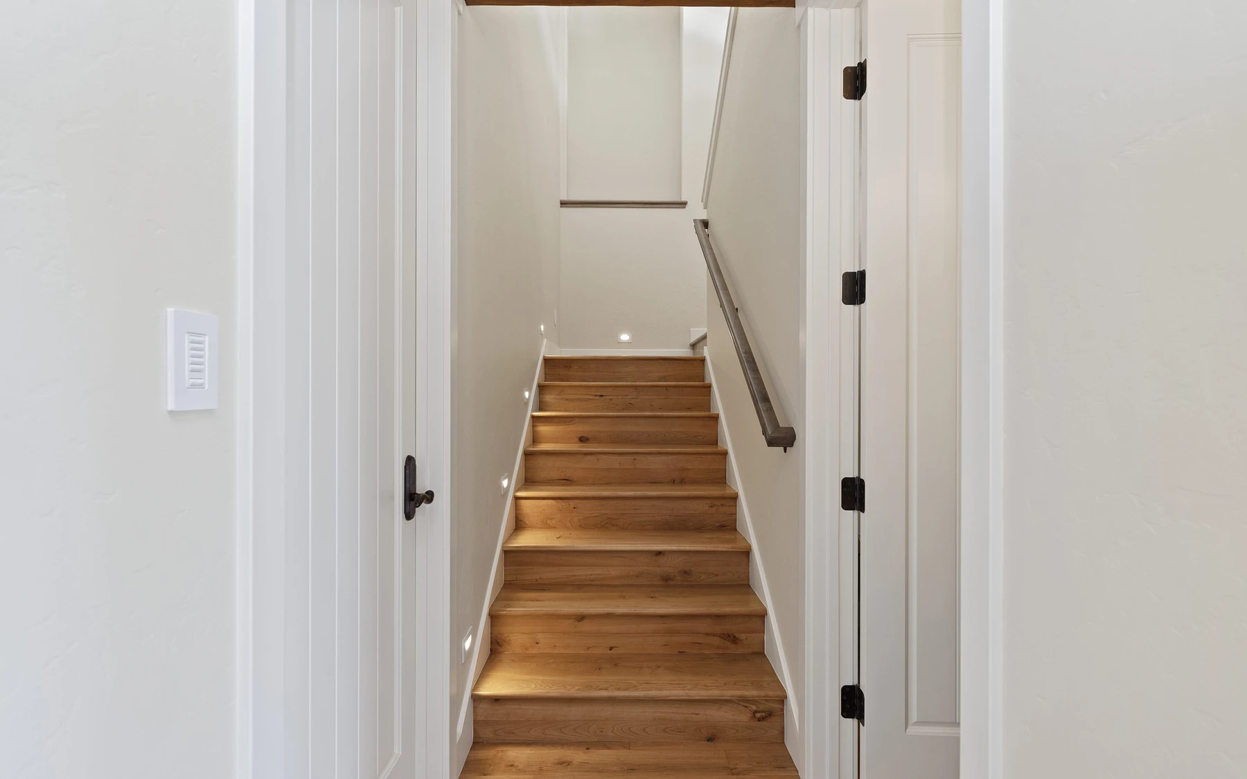 Stair hall in the Club Hill Refresh remodel at Whitetail Club, with a custom staircase and wood railings.
