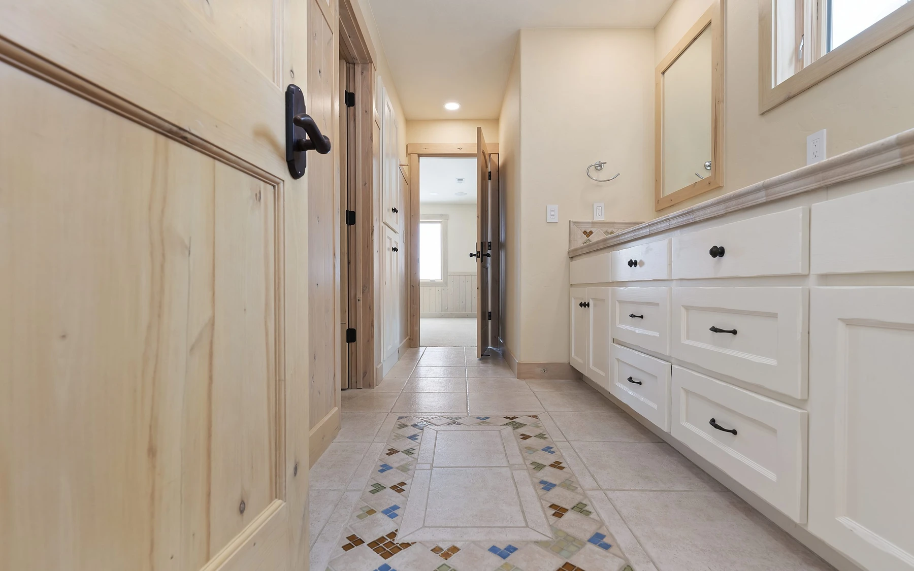 Interior detail in the Club Hill Refresh remodel at Whitetail Club, showing built-in cabinetry, large windows, and wood finishes.