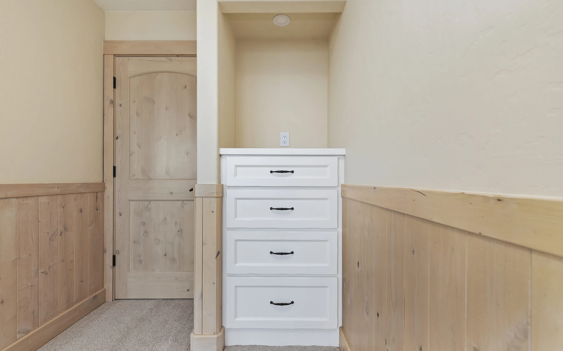 Dressing room in the Club Hill Refresh remodel at Whitetail Club, with built-in storage and wood cabinetry.