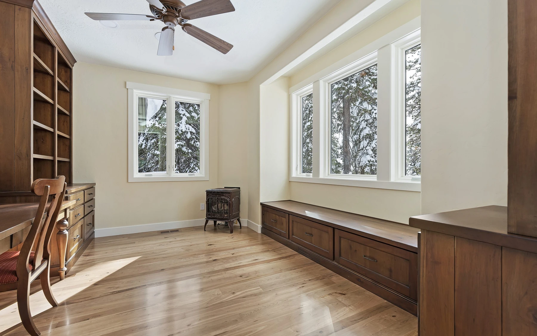 Interior detail in the Club Hill Refresh remodel at Whitetail Club, showing built-in cabinetry, large windows, and wood finishes.