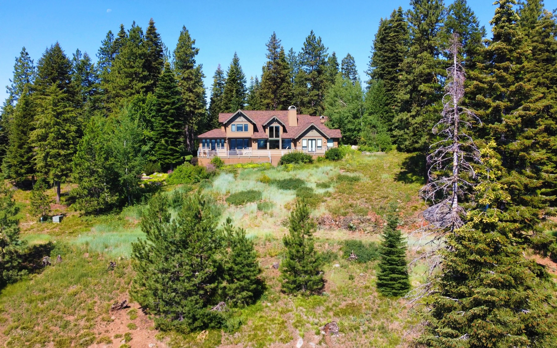 Exterior of the Club Hill Refresh remodel at Whitetail Club, showing the surrounding forest.