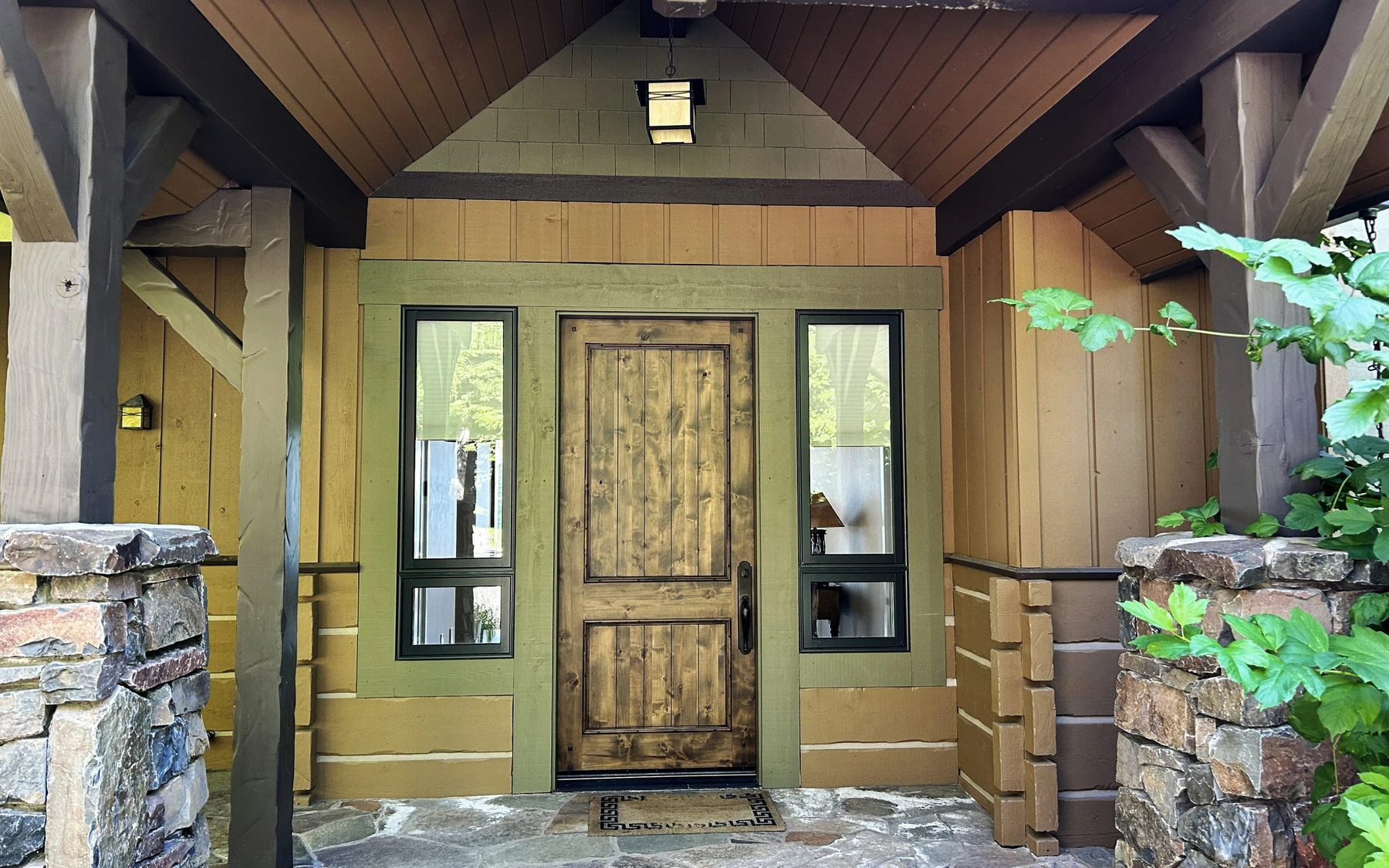 Interior detail in the Club Hill Refresh remodel at Whitetail Club, showing large windows, wood finishes, and stone details.
