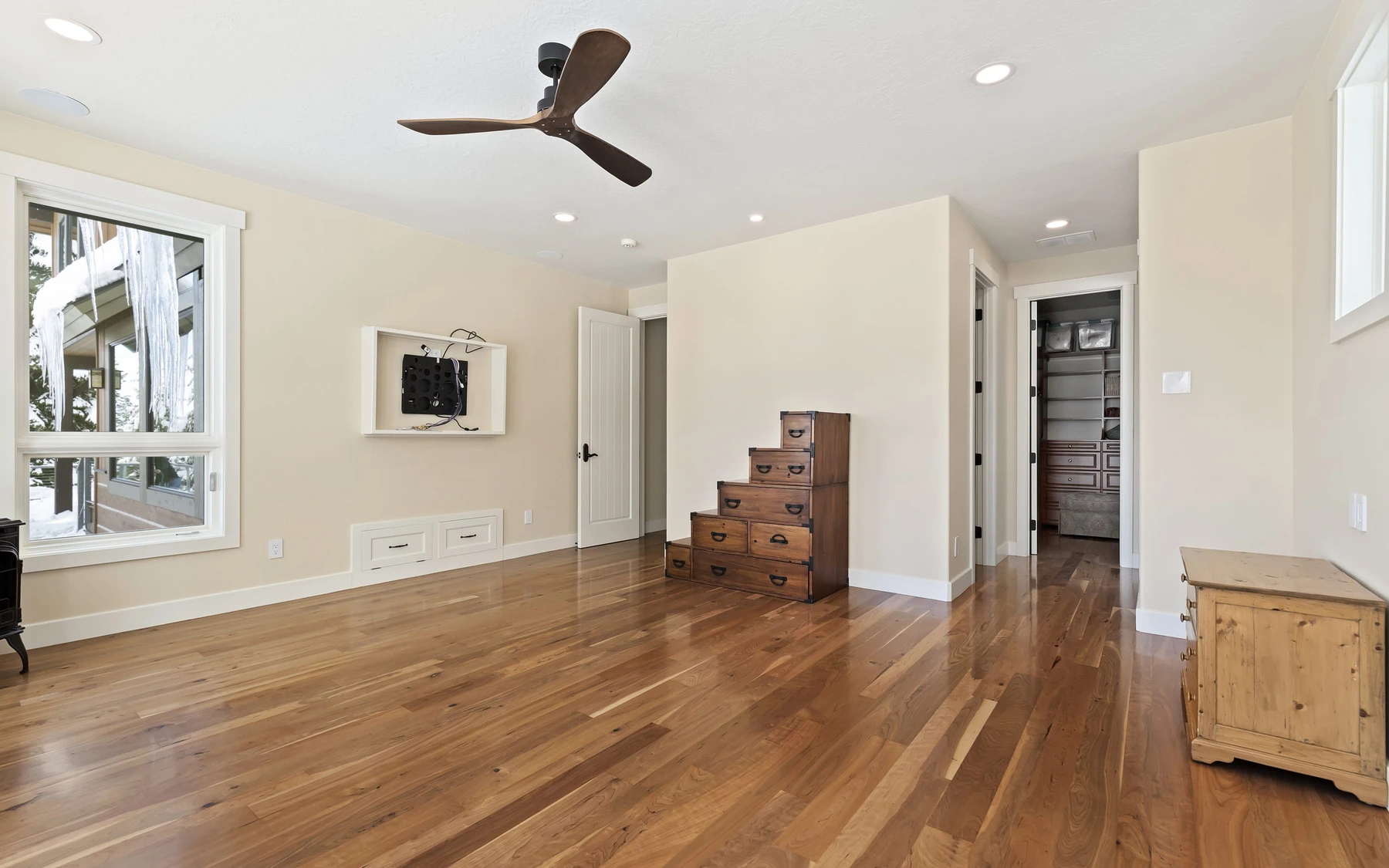 Interior detail in the Club Hill Refresh remodel at Whitetail Club, showing built-in cabinetry, large windows, and wood finishes.