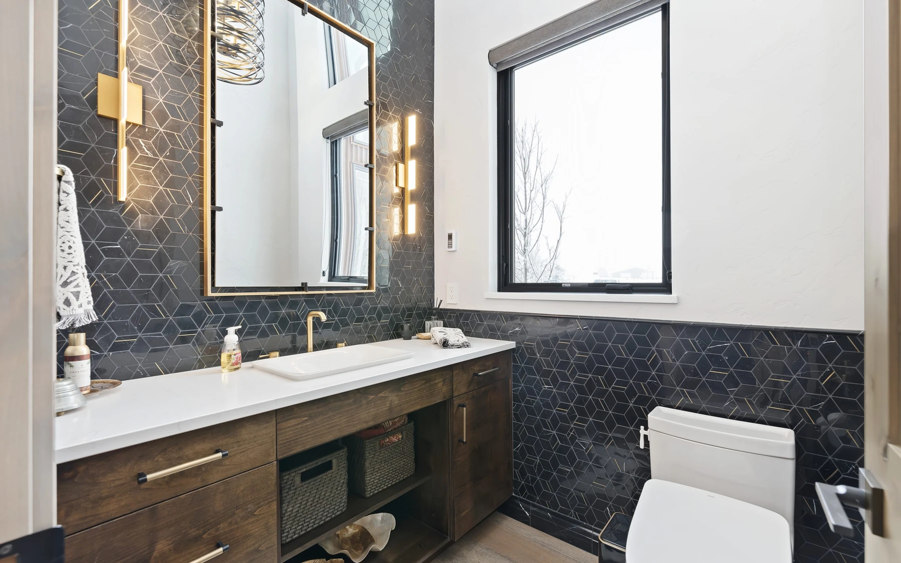 Bathroom in the Contemporary Hideaway custom home near McCall, with a custom vanity, wood cabinetry, and natural light.