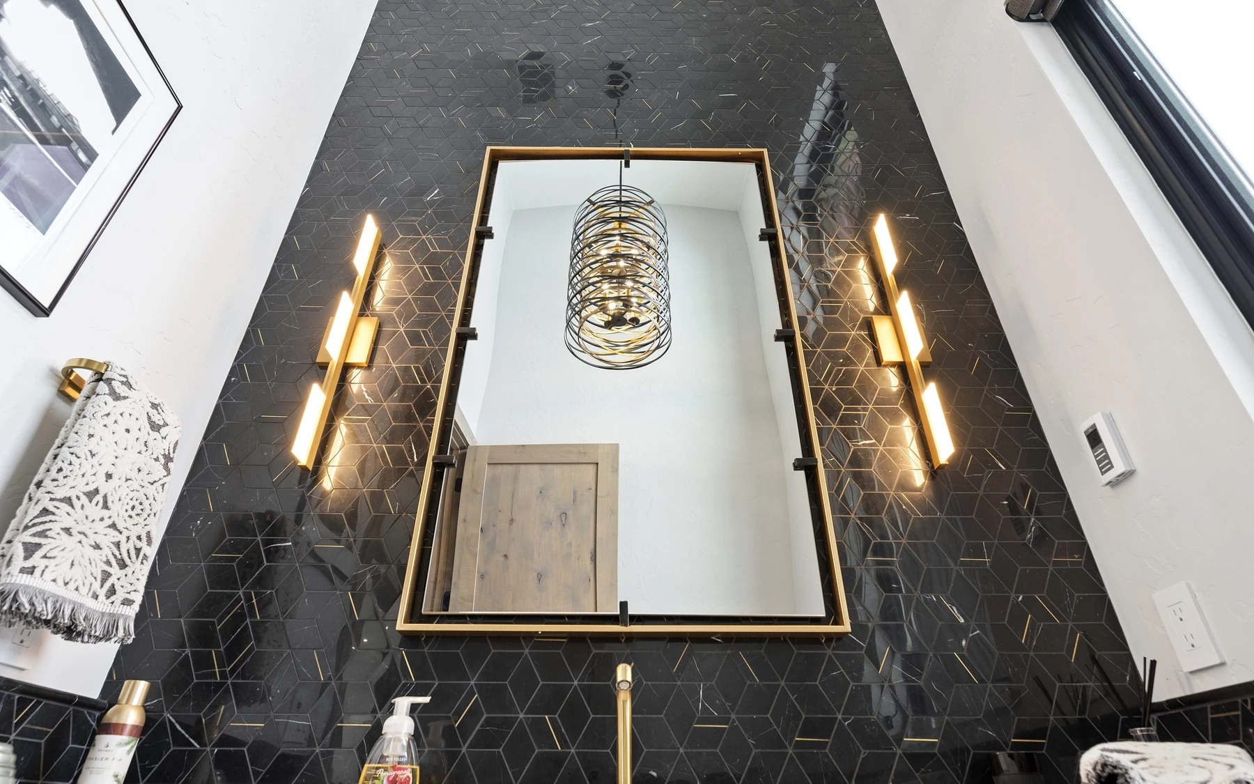 Interior detail in the Contemporary Hideaway custom home near McCall, showing framed artwork and decorative lighting.