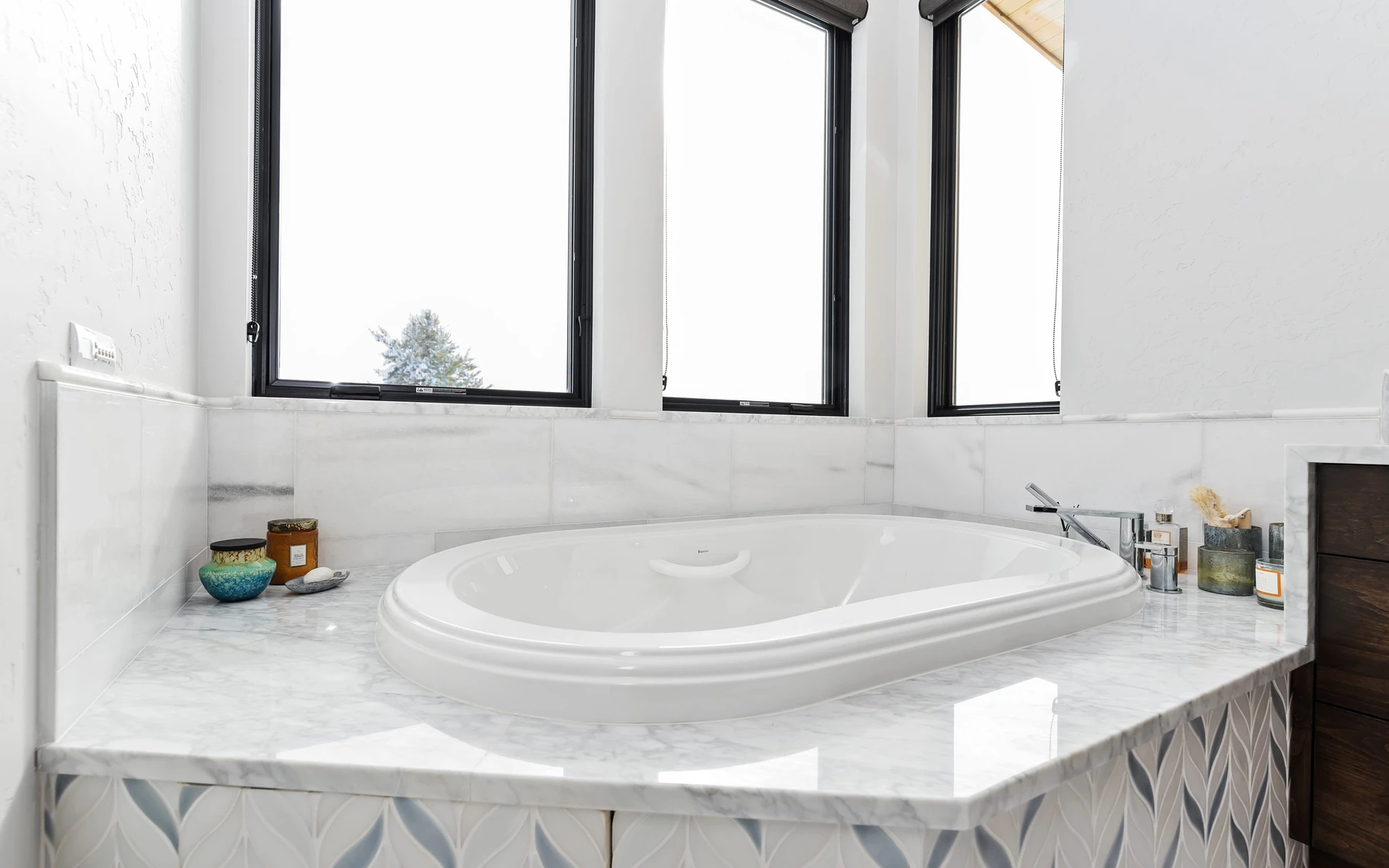 Bathroom in the Contemporary Hideaway custom home near McCall, with a soaking tub, a custom vanity, and wood cabinetry.