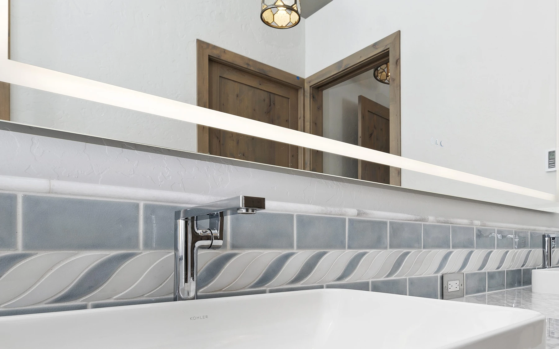 Bathroom in the Contemporary Hideaway custom home near McCall, with a custom vanity and wood cabinetry.