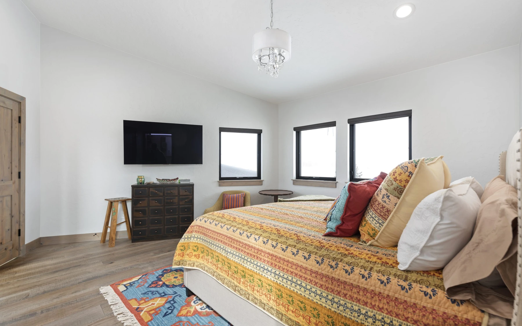 Bedroom in the Contemporary Hideaway custom home near McCall, with a layered bed and wood details.