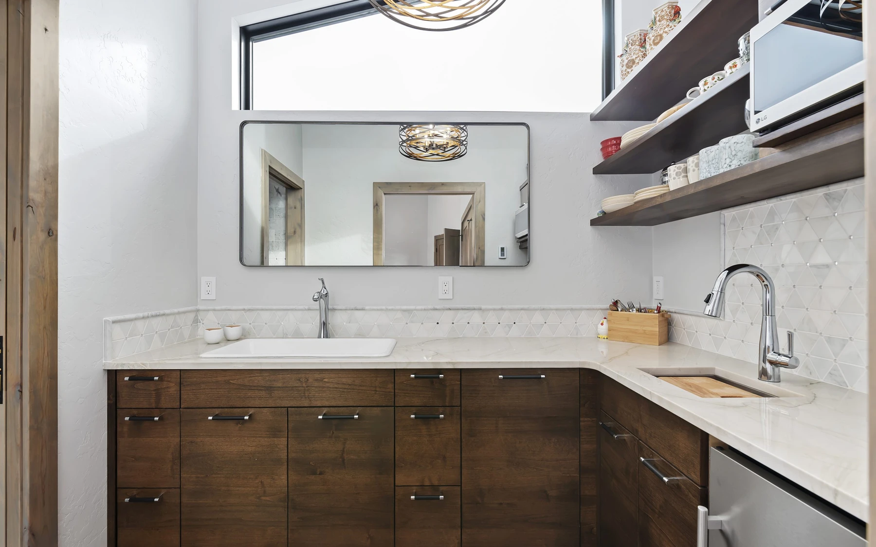Kitchen in the Contemporary Hideaway custom home near McCall, with wood cabinetry.