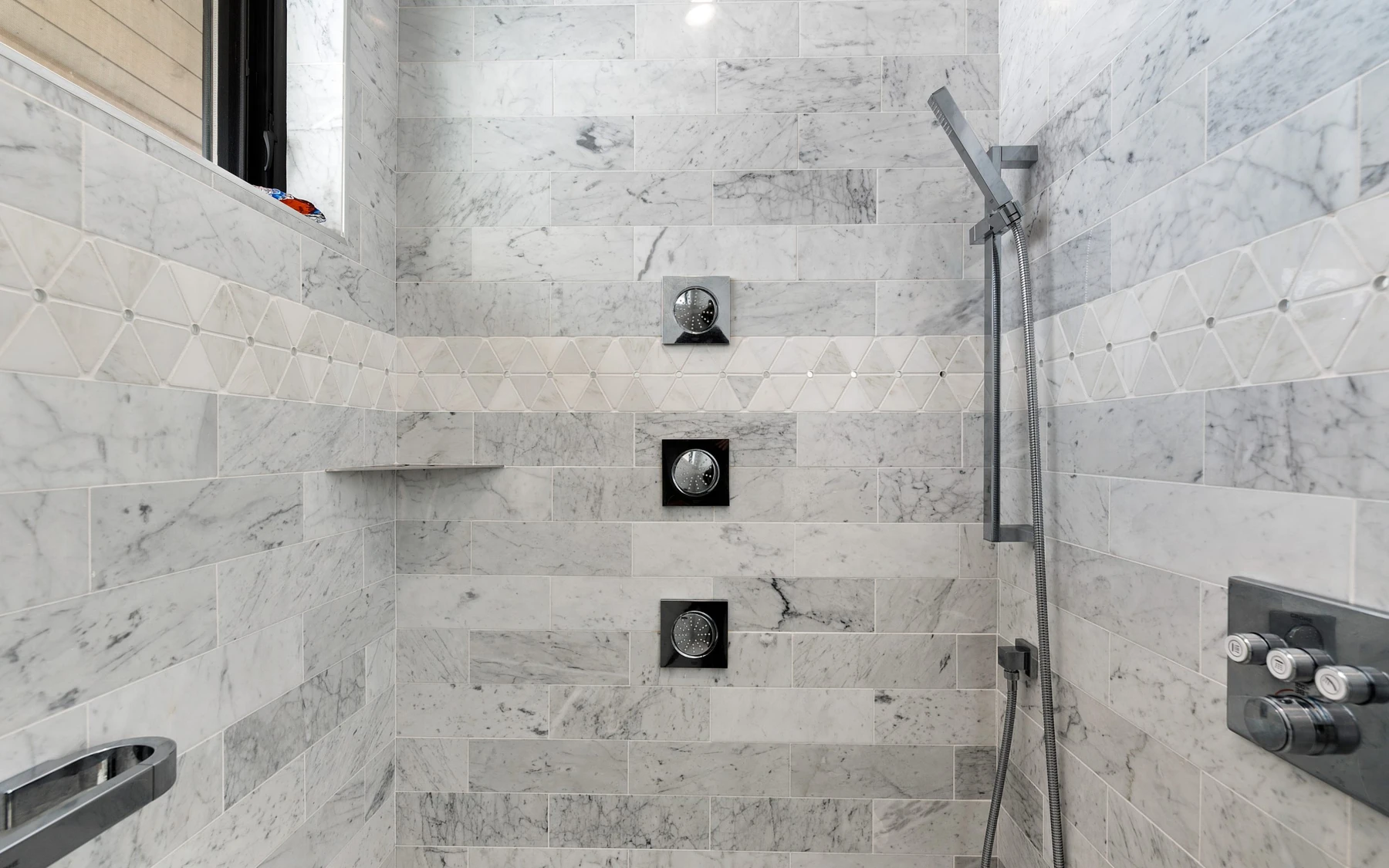 Bathroom in the Contemporary Hideaway custom home near McCall, with a glass shower and natural light.