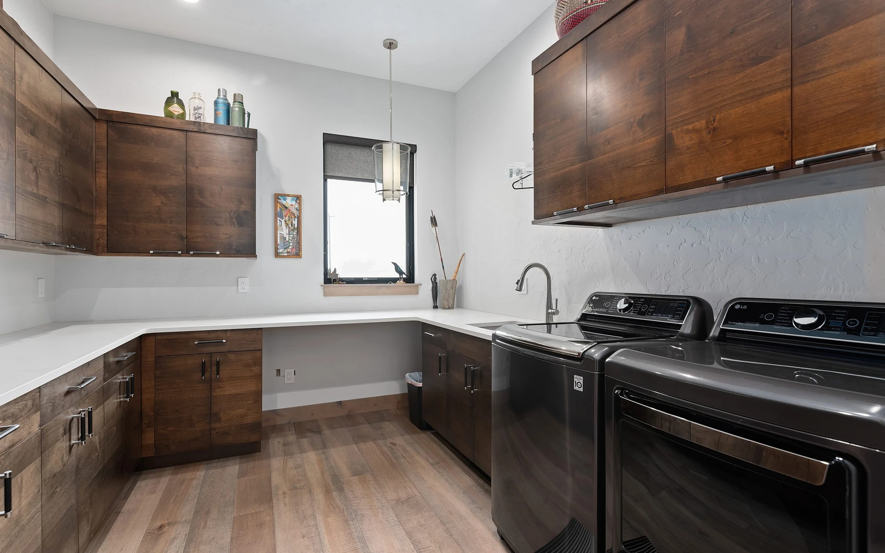 Kitchen in the Contemporary Hideaway custom home near McCall, with wood cabinetry, a broad countertop, and integrated appliances.