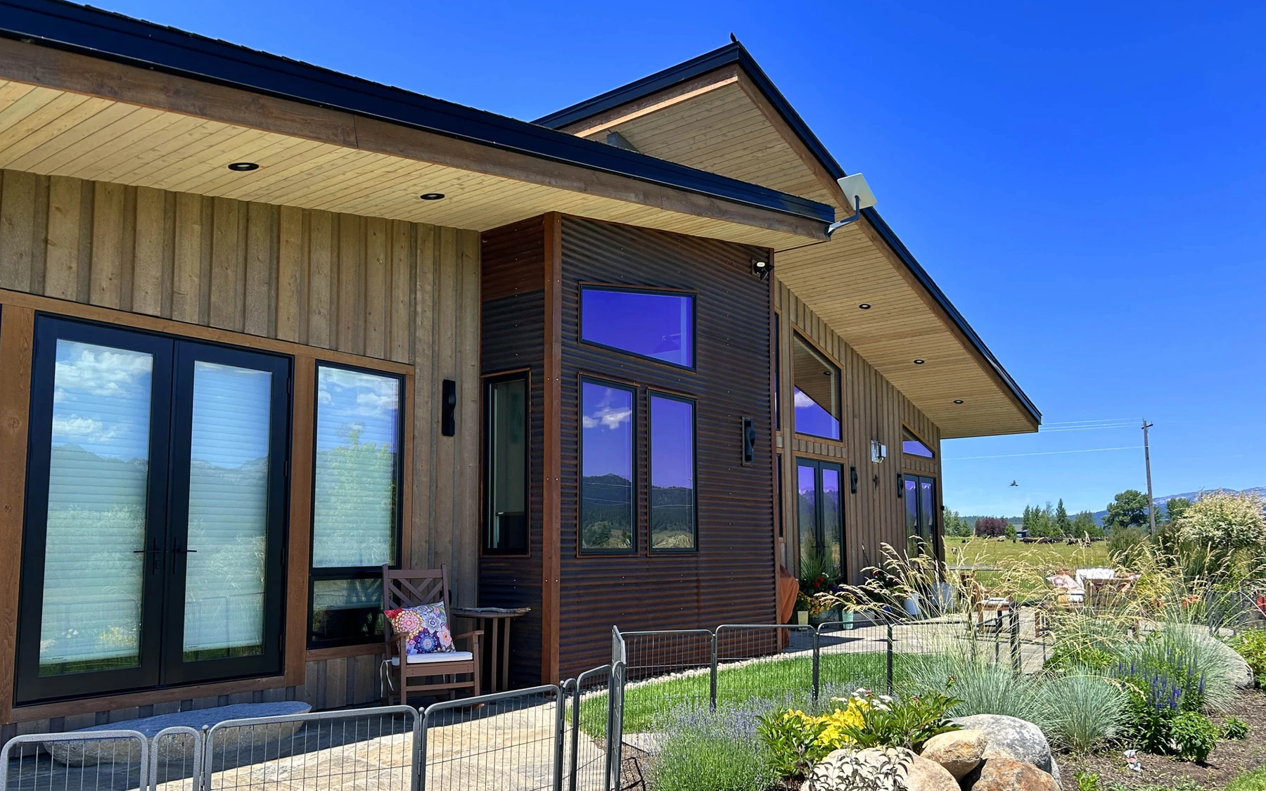 Covered outdoor space at the Contemporary Hideaway custom home near McCall, with timber details.