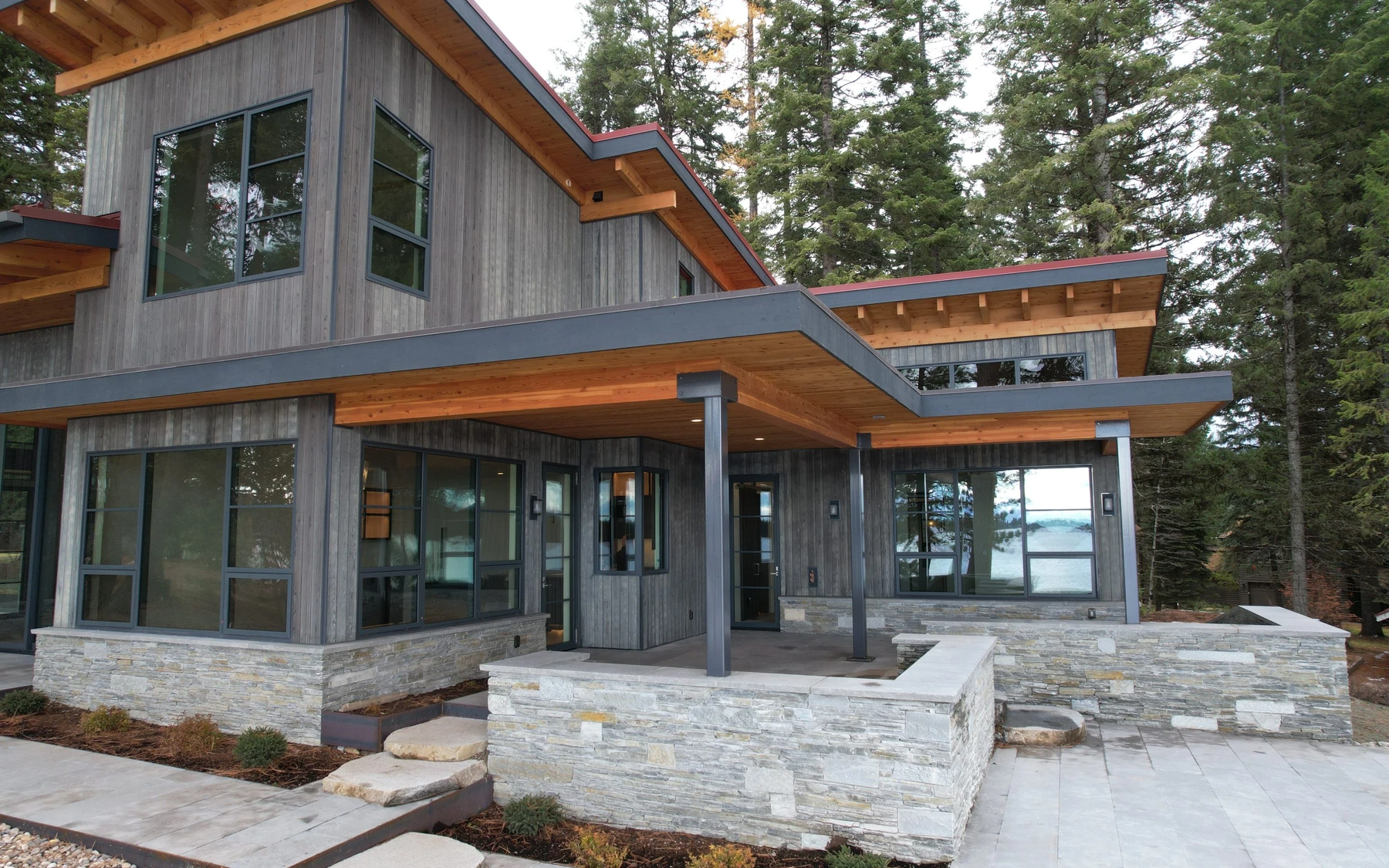 Aerial view of the Modern Elegance custom home near McCall, showing the surrounding forest.