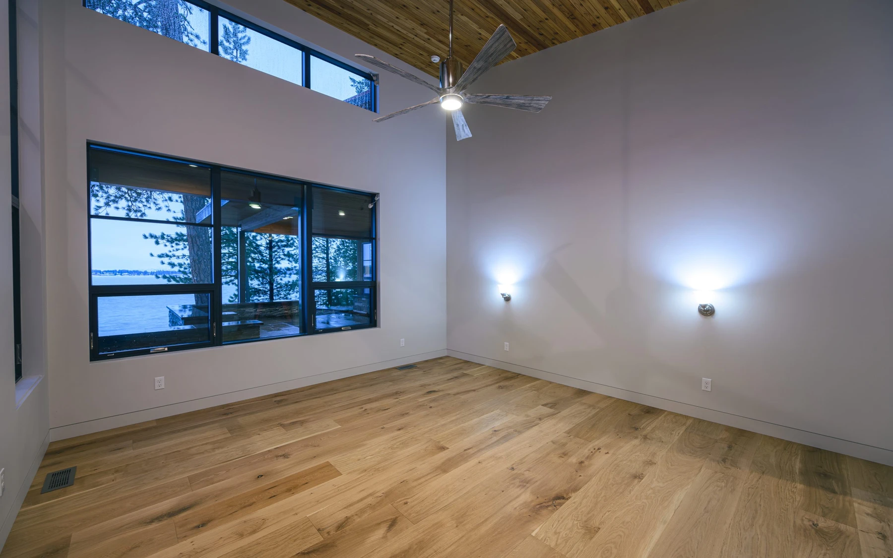 Interior detail in the Modern Elegance custom home near McCall, showing large windows, wood finishes, and decorative lighting.