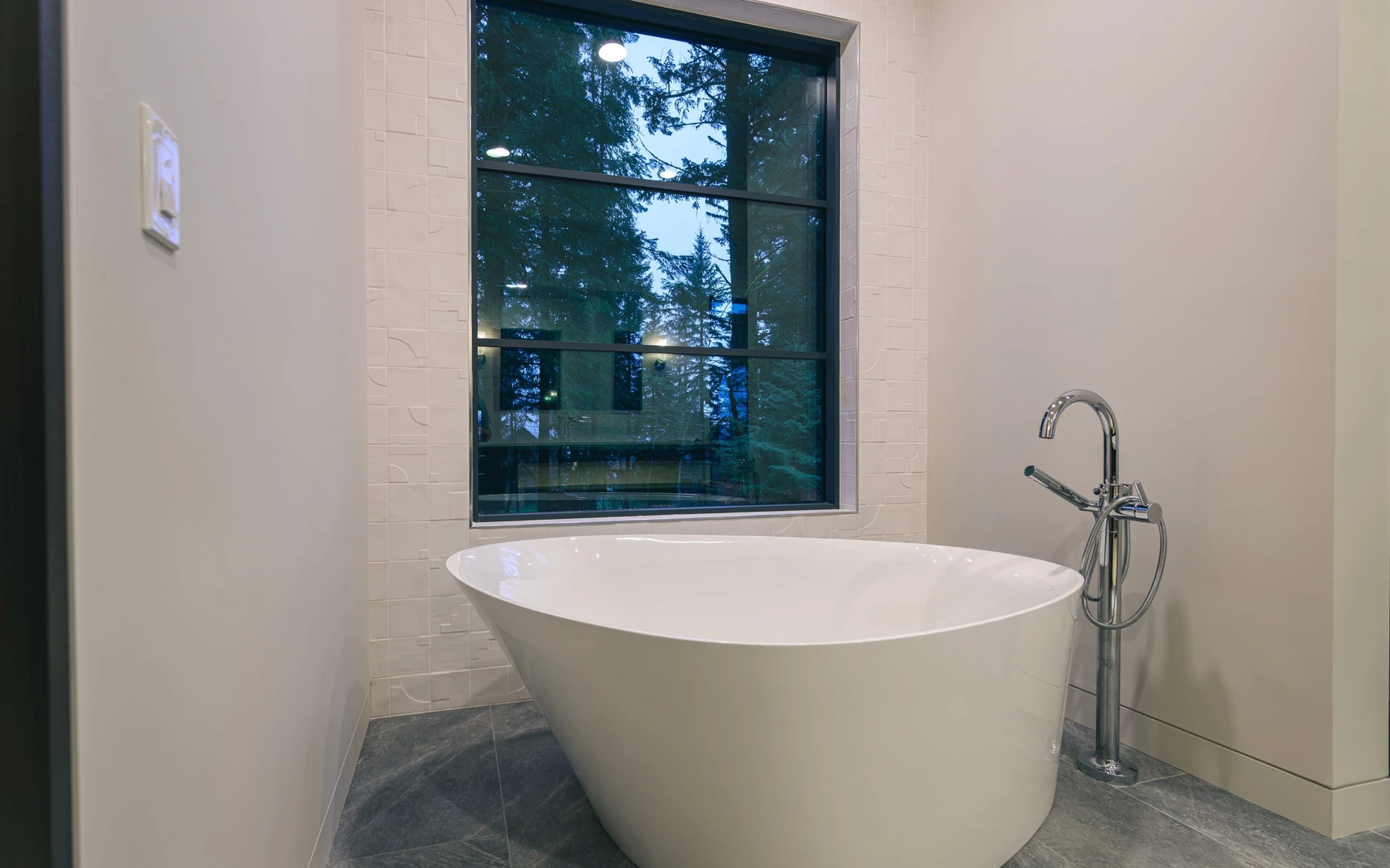Bathroom in the Modern Elegance custom home near McCall, with a soaking tub, a glass shower, and a custom vanity.