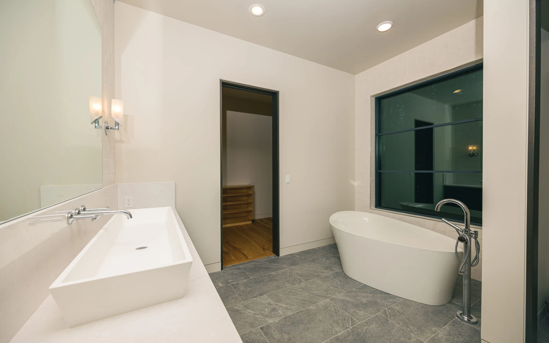 Bathroom in the Modern Elegance custom home near McCall, with a soaking tub, a glass shower, and a custom vanity.