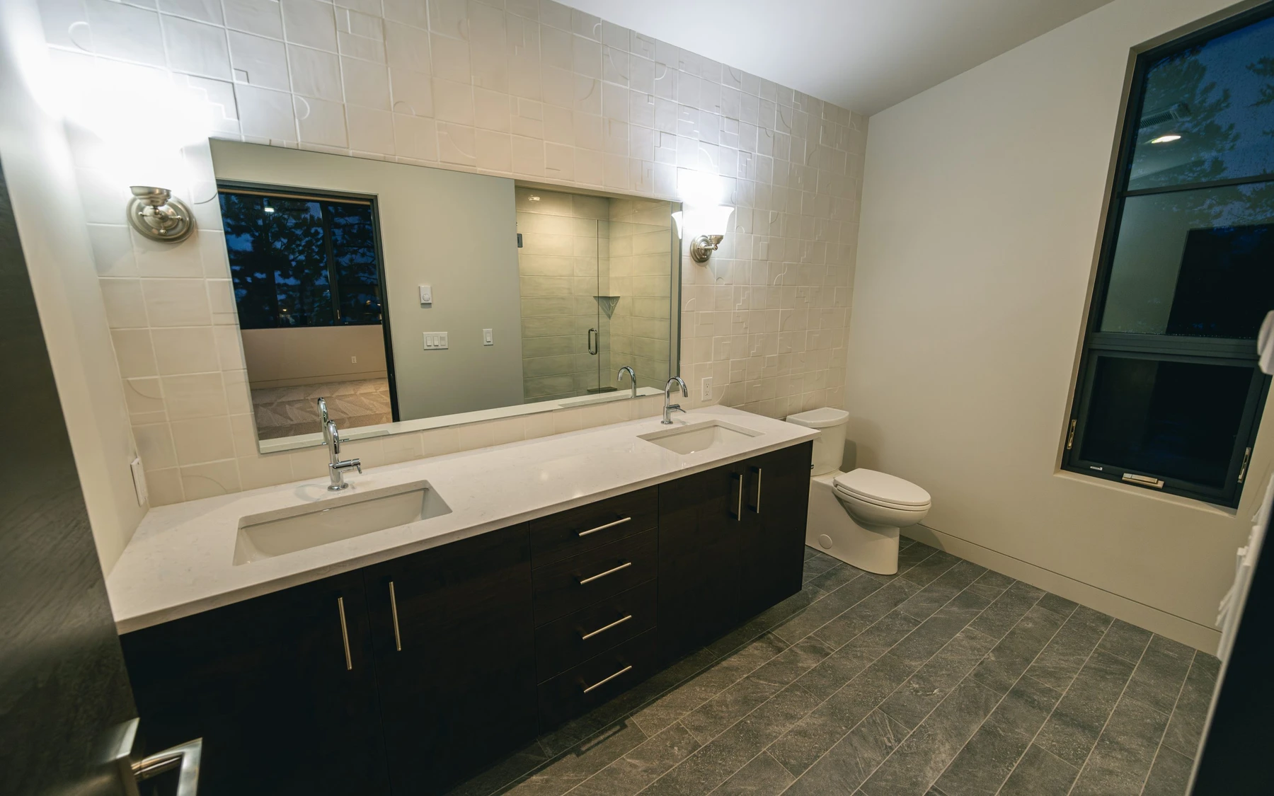 Bathroom in the Modern Elegance custom home near McCall, with a soaking tub, a custom vanity, and wood cabinetry.