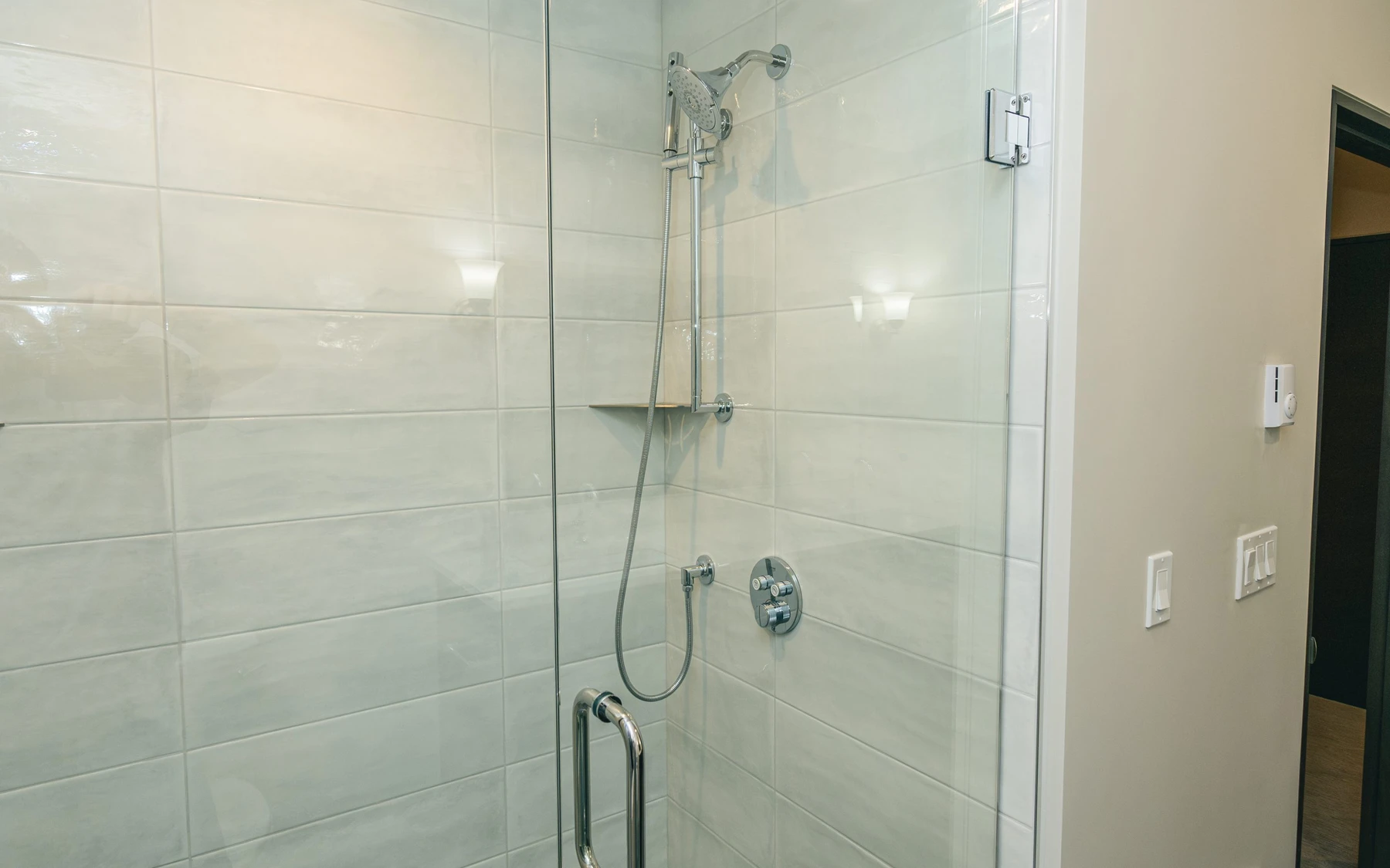Bathroom in the Modern Elegance custom home near McCall, with a glass shower and natural light.