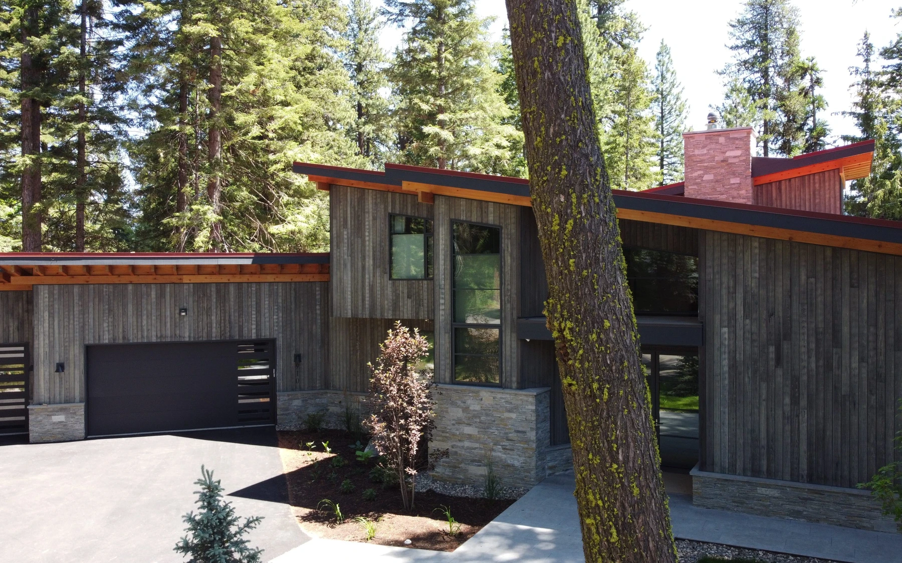 Aerial view of the Modern Elegance custom home near McCall, showing the surrounding forest.