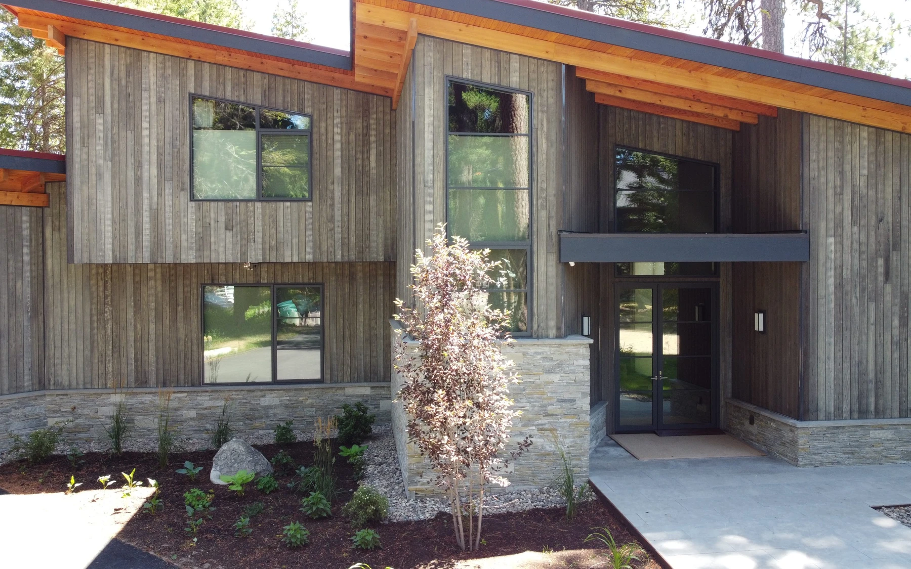 Aerial view of the Modern Elegance custom home near McCall, showing the surrounding forest.