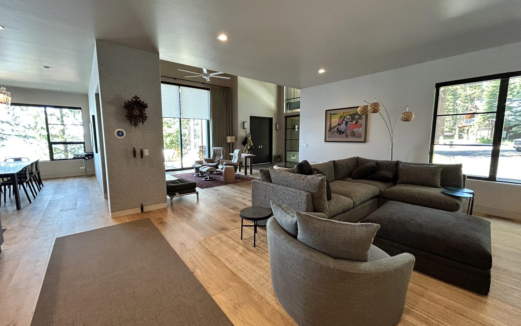 Living room in the Modern Elegance custom home near McCall, with a relaxed seating area, large windows, and warm wood finishes.