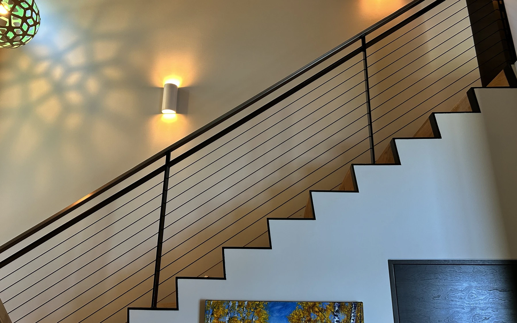 Stair hall in the Modern Elegance custom home near McCall, with a custom staircase.