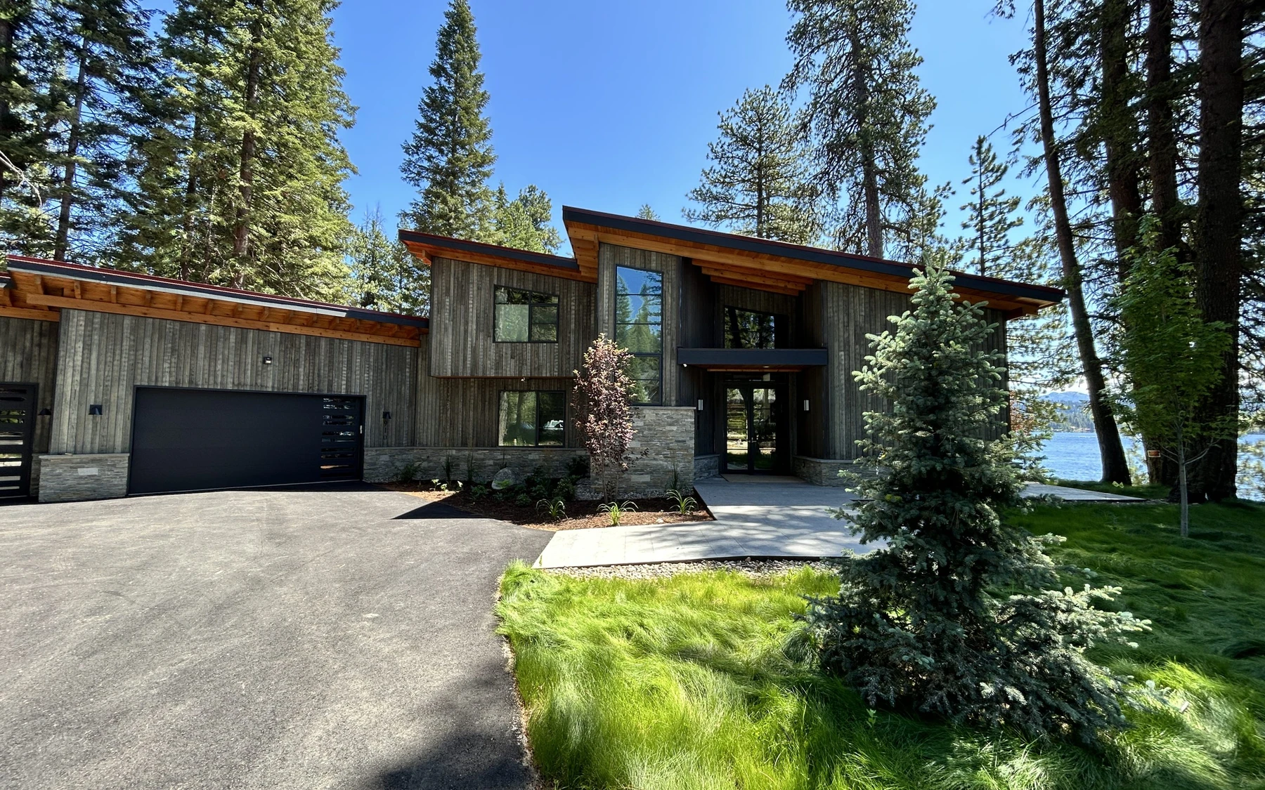 Garage approach at the Modern Elegance custom home near McCall, with an attached garage and a broad driveway.
