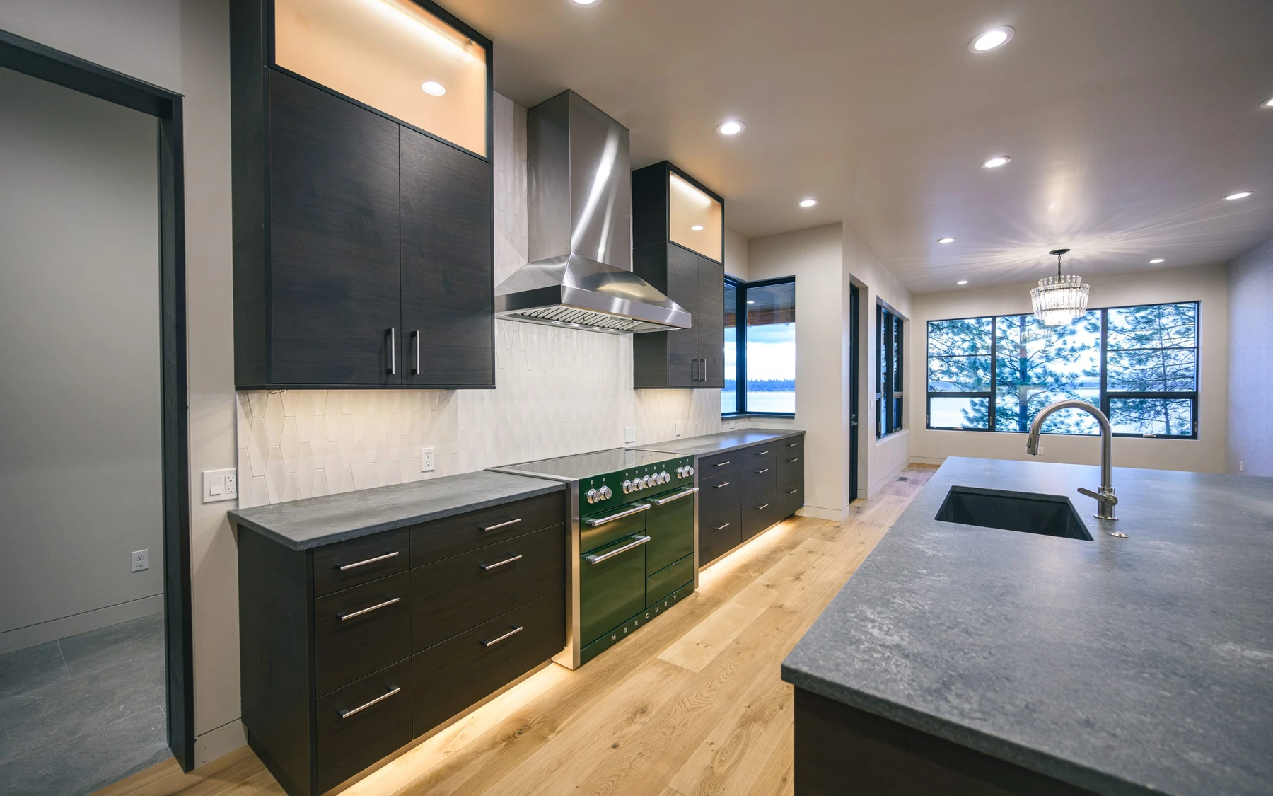 Kitchen in the Modern Elegance custom home near McCall, with wood cabinetry, a broad countertop, and integrated appliances.