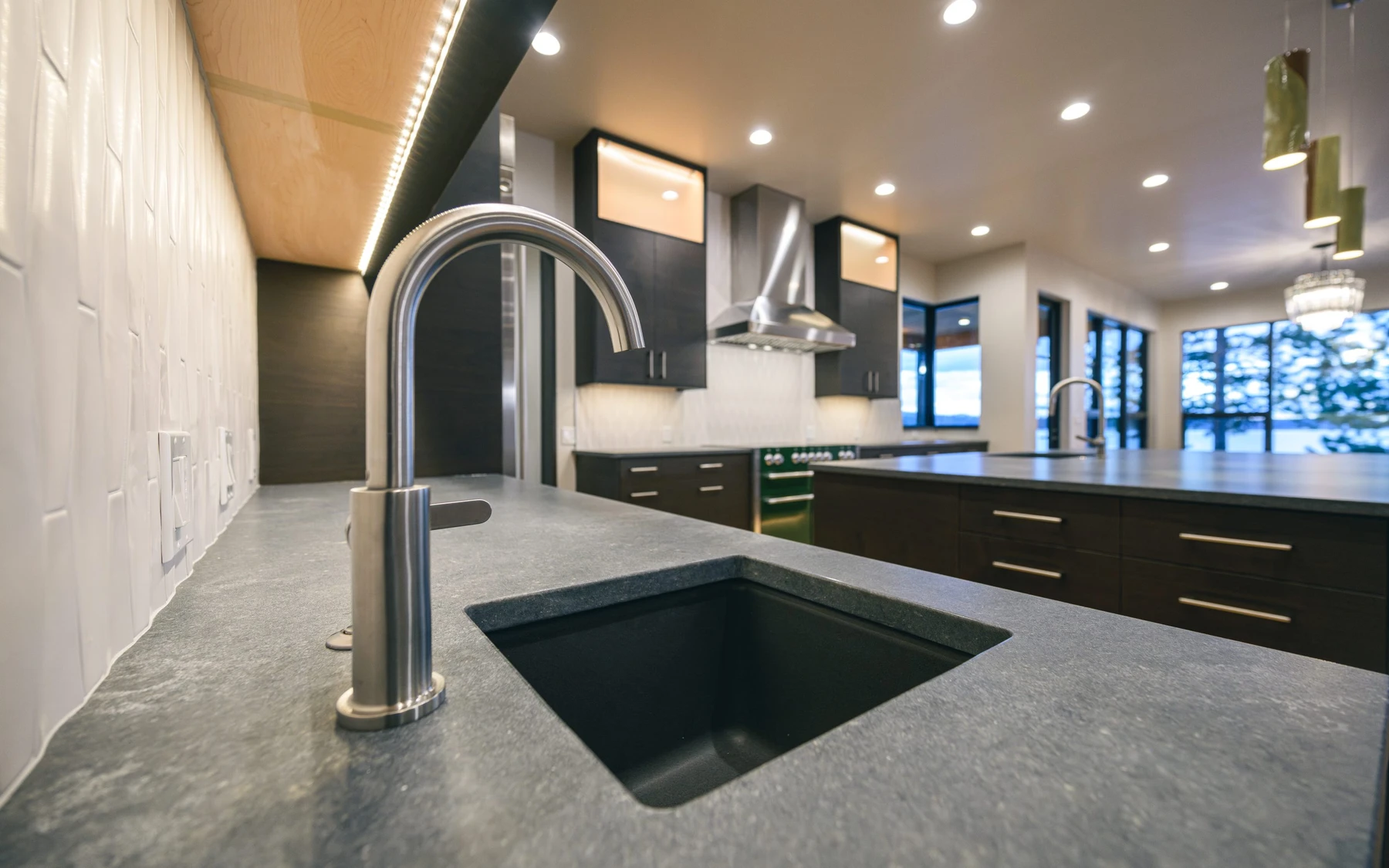 Kitchen in the Modern Elegance custom home near McCall, with wood cabinetry and a broad countertop.