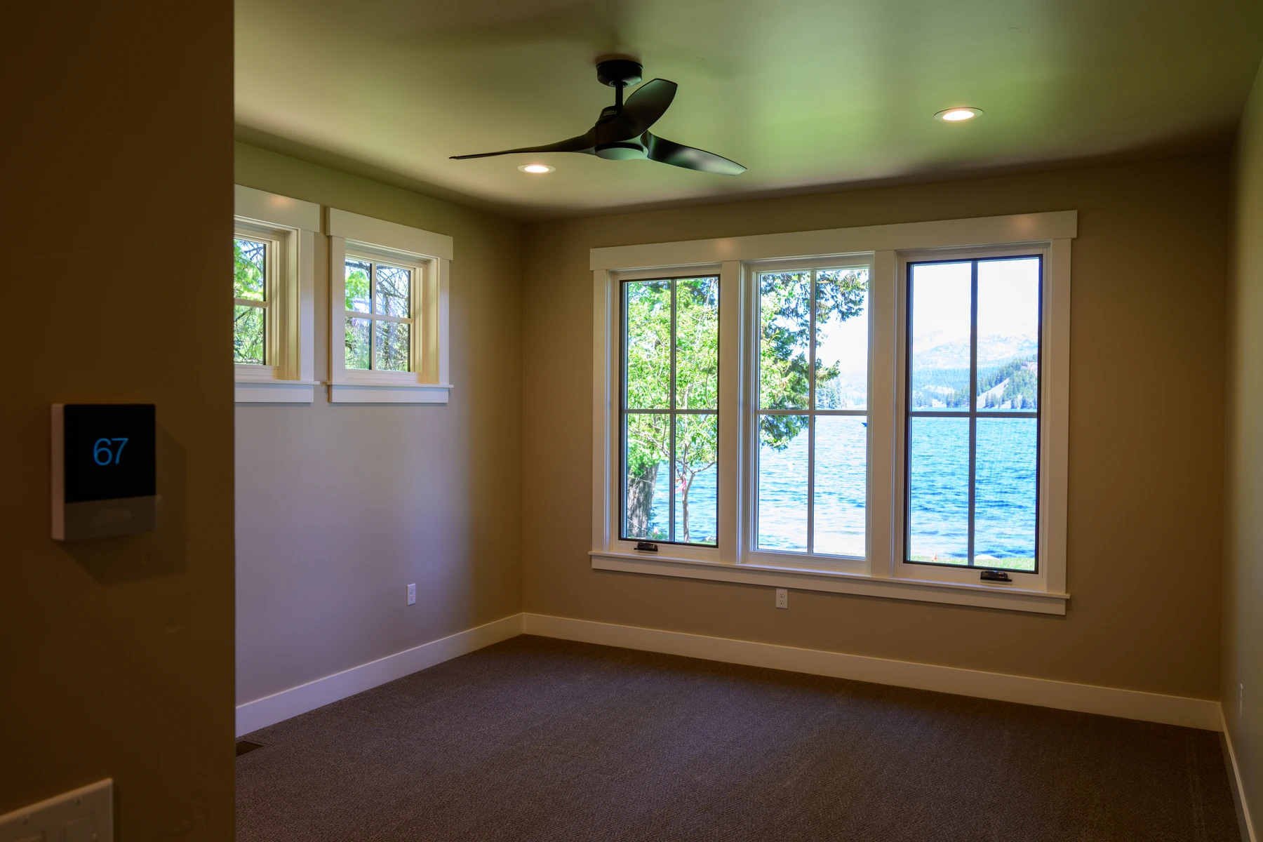 Bedroom with corner windows overlooking the lake
