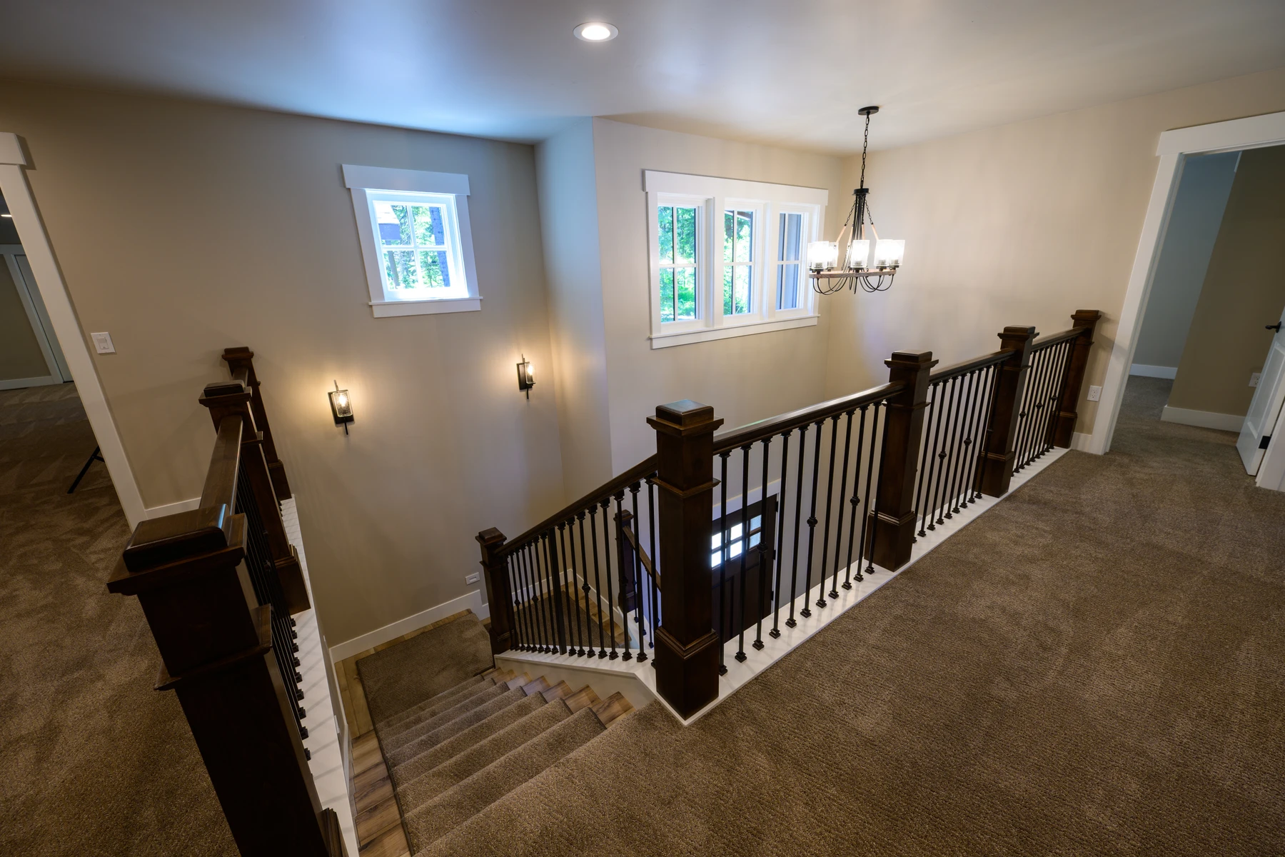 Open staircase and upper landing lit by tall stairwell windows