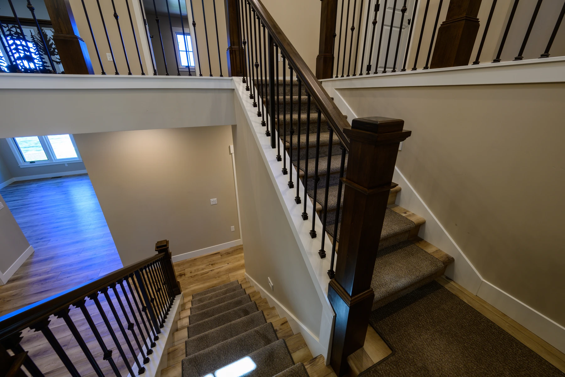 Dark wood staircase connecting the entry hall and upper landing