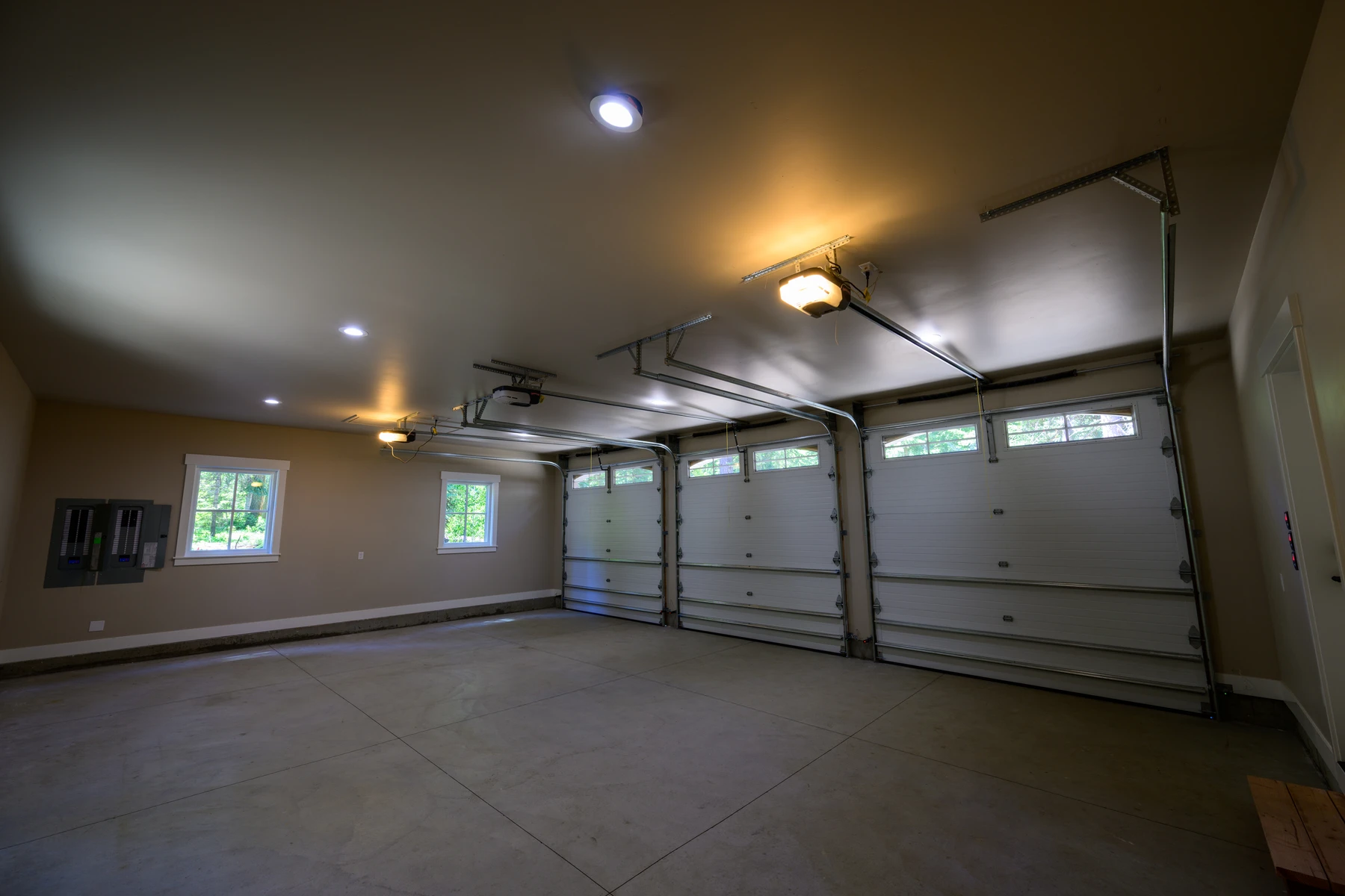Finished three-bay garage with wood-look doors and high windows
