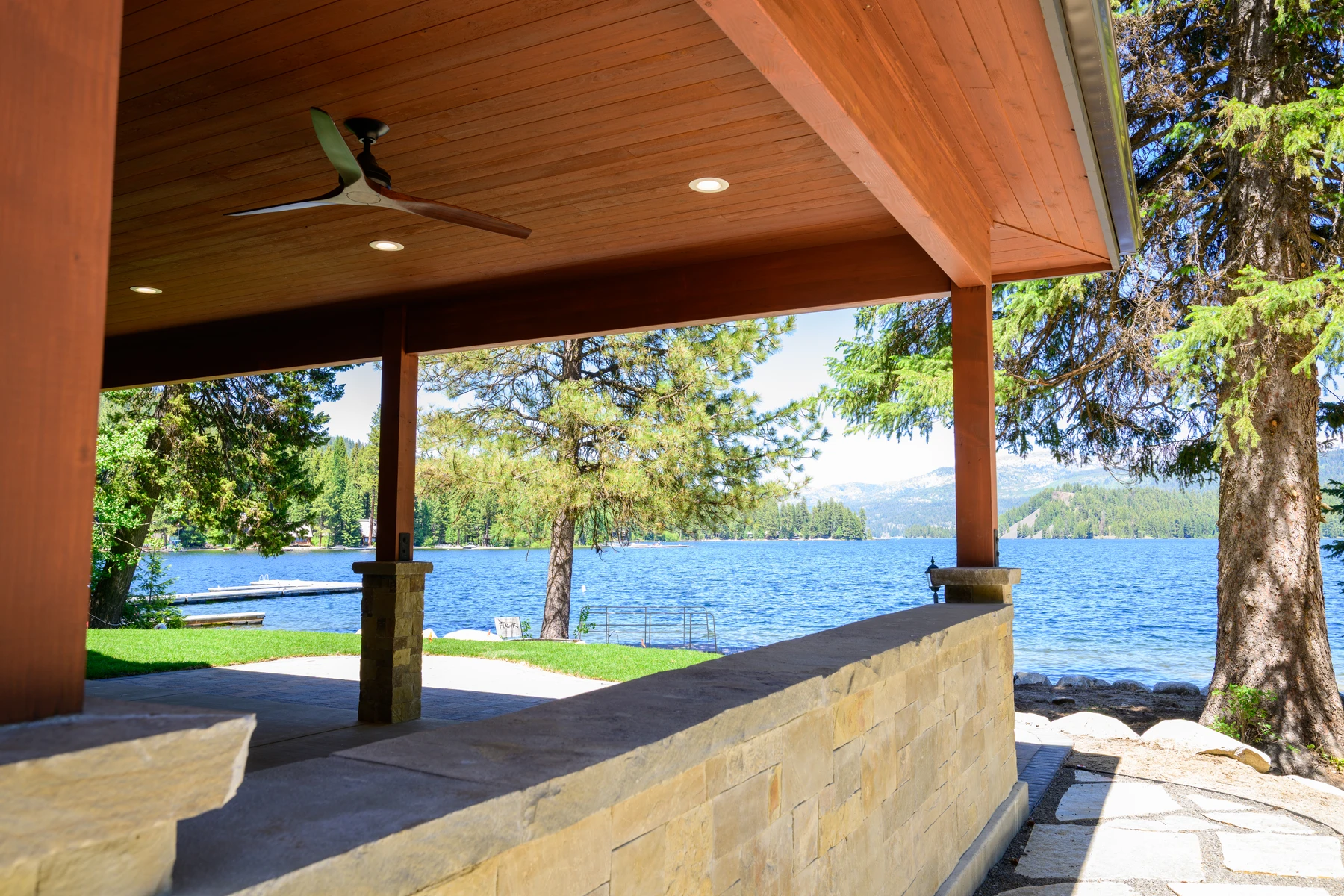 View from the covered stone patio across the lawn to the lake