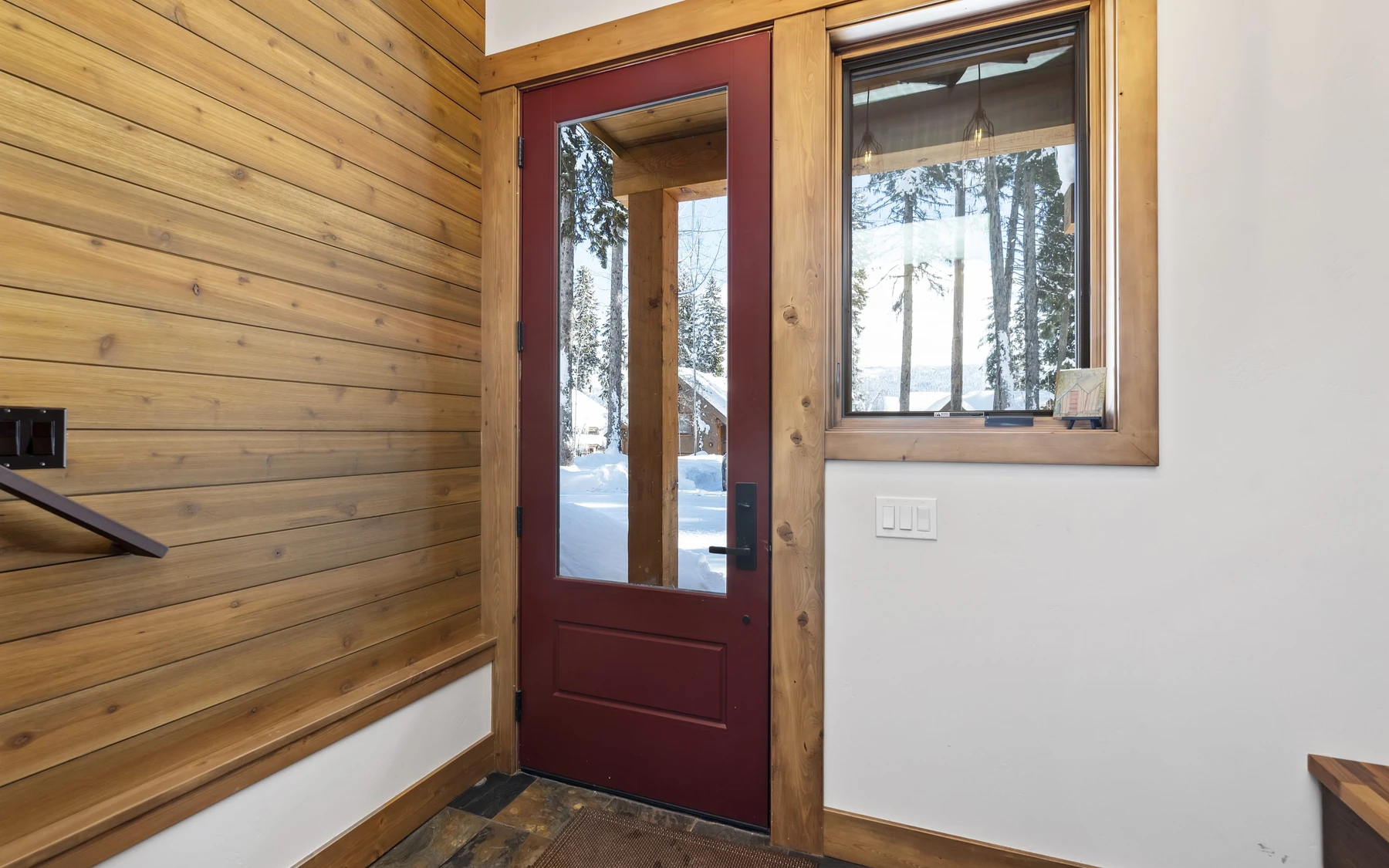 Interior detail in the Plymouth Retreat mountain home near McCall, showing large windows and wood finishes.