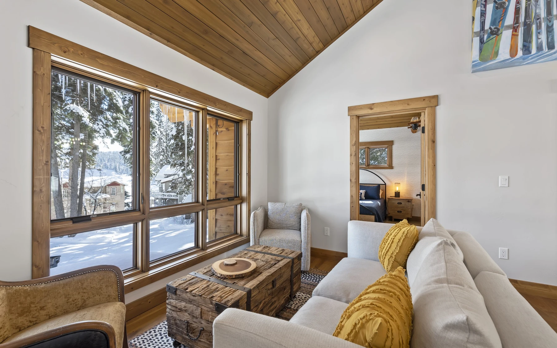 Living room in the Plymouth Retreat mountain home near McCall, with a relaxed seating area, large windows, and warm wood finishes.