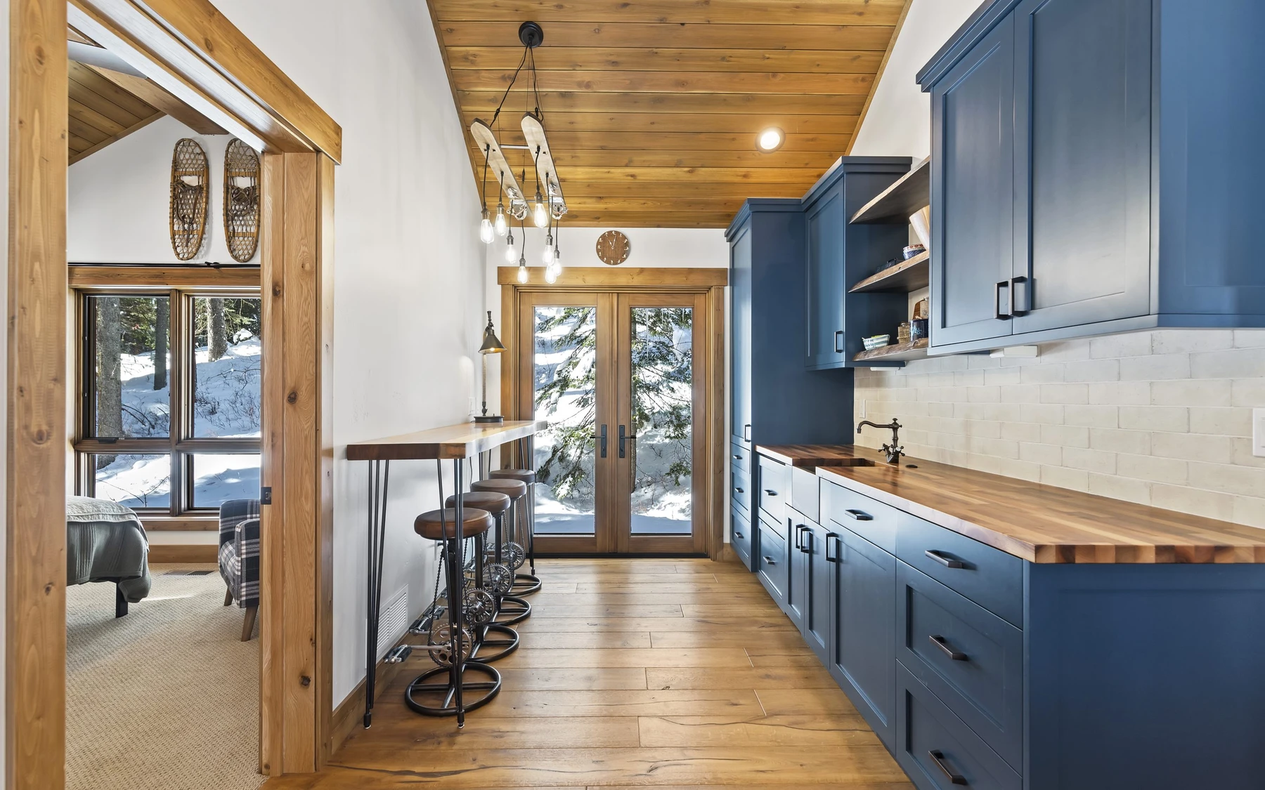 Interior detail in the Plymouth Retreat mountain home near McCall, showing built-in cabinetry, large windows, and wood finishes.
