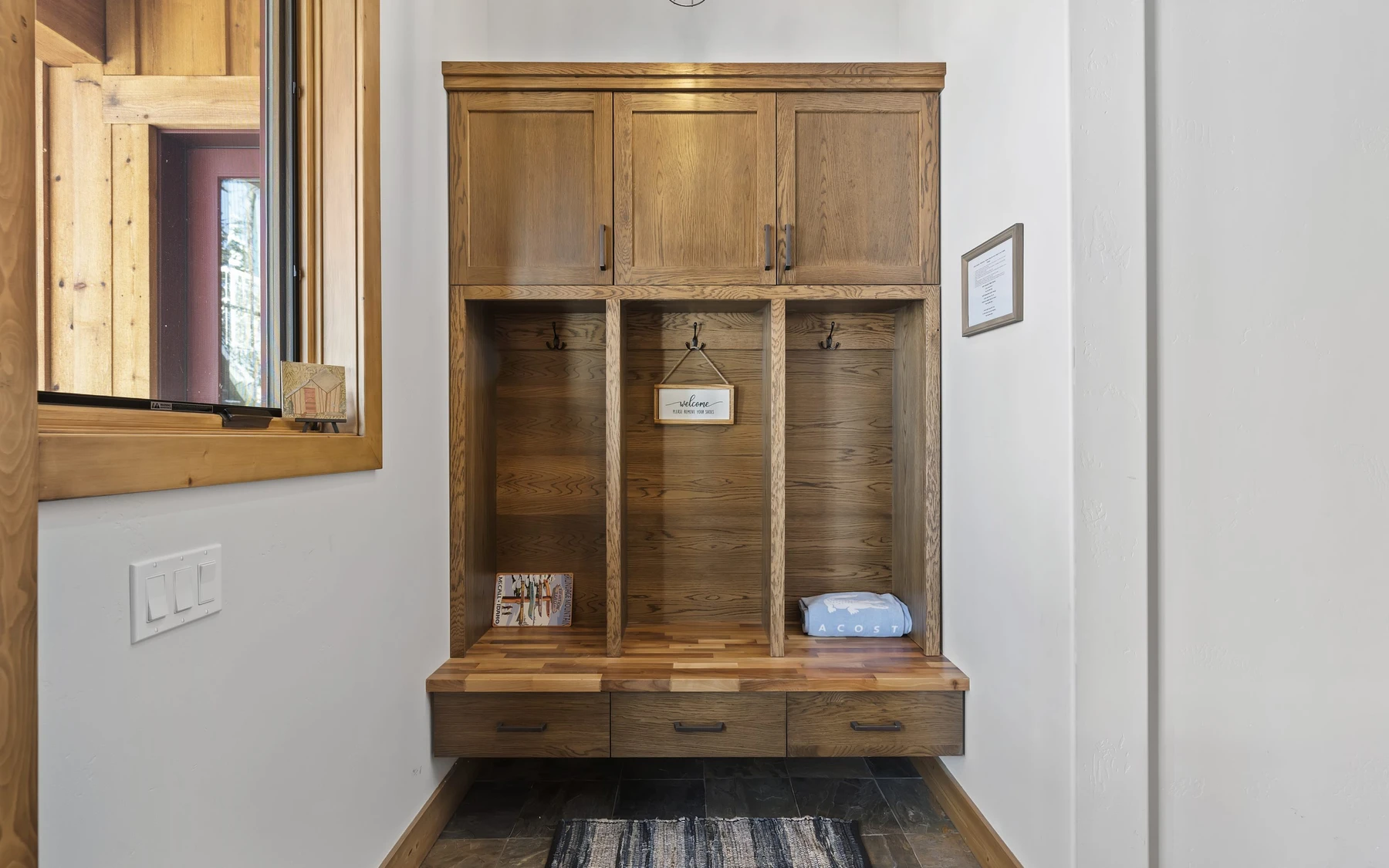 Interior detail in the Plymouth Retreat mountain home near McCall, showing built-in cabinetry, large windows, and wood finishes.
