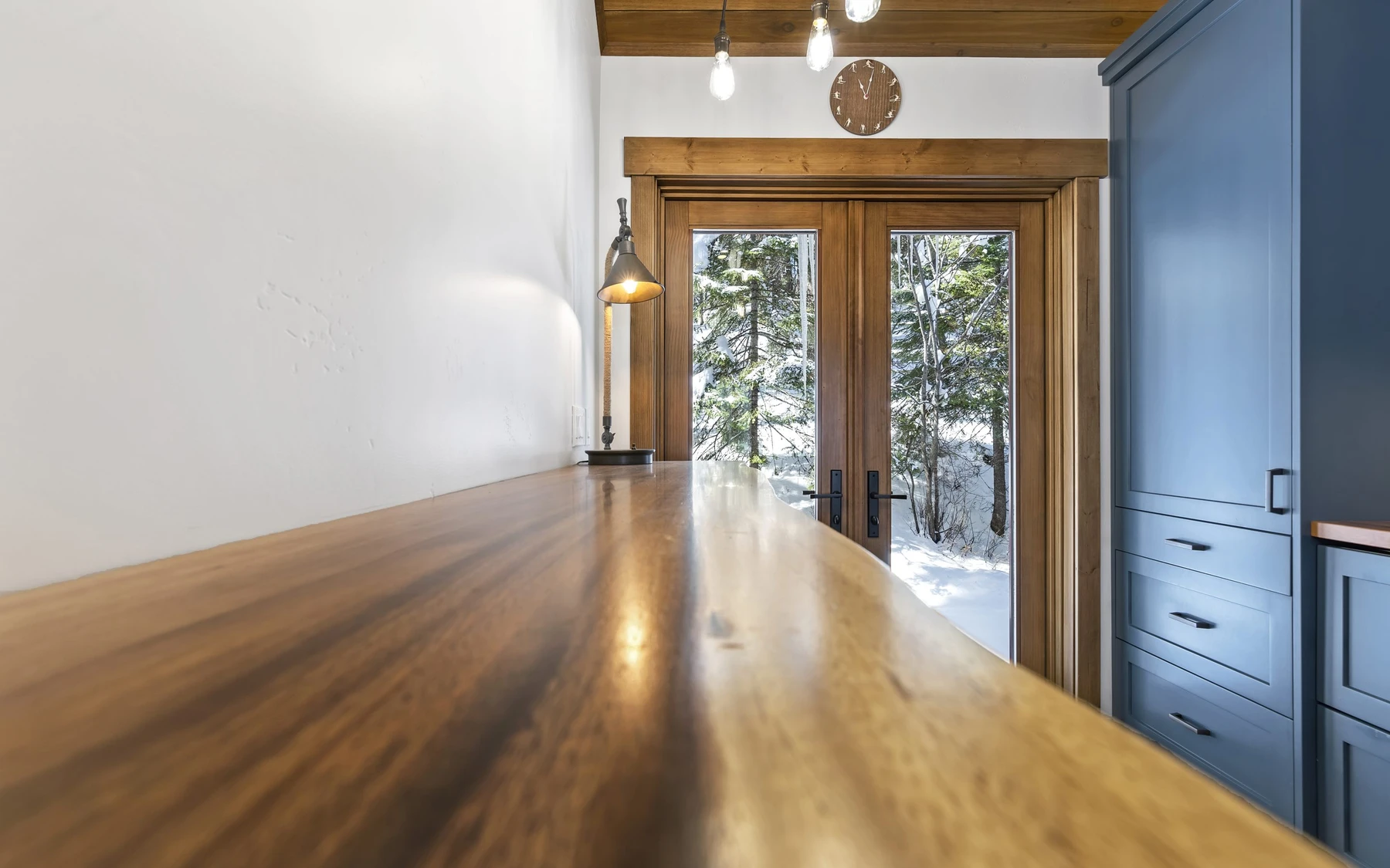 Interior detail in the Plymouth Retreat mountain home near McCall, showing built-in cabinetry, large windows, and wood finishes.