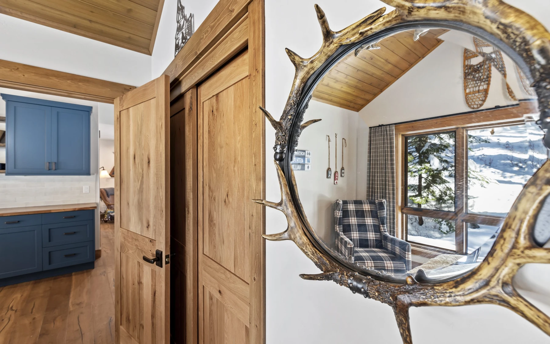 Interior detail in the Plymouth Retreat mountain home near McCall, showing built-in cabinetry, large windows, and wood finishes.