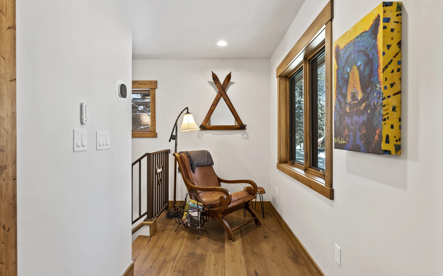 Interior detail in the Plymouth Retreat mountain home near McCall, showing large windows, wood finishes, and framed artwork.