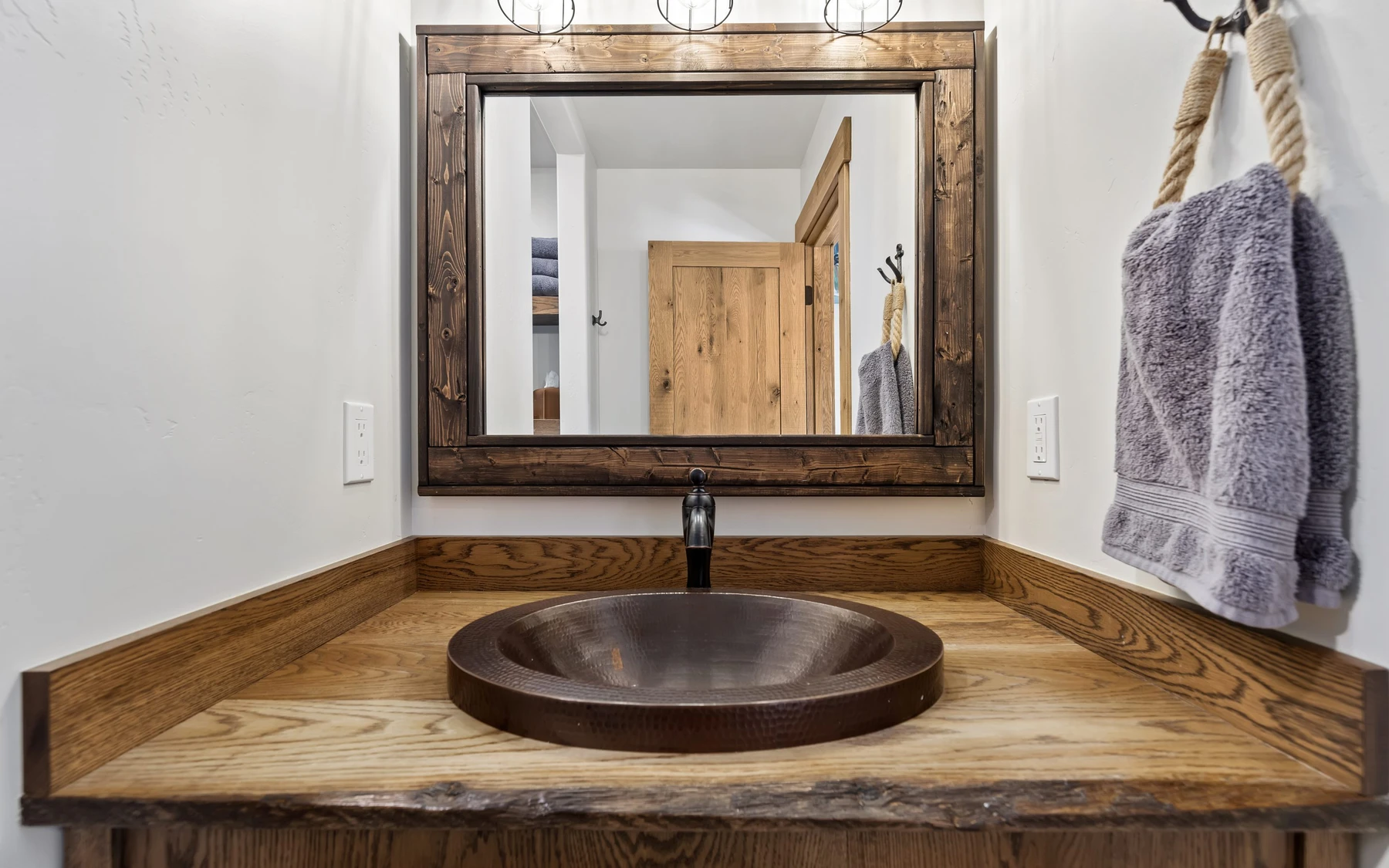 Bathroom in the Plymouth Retreat mountain home near McCall, with a custom vanity and wood cabinetry.