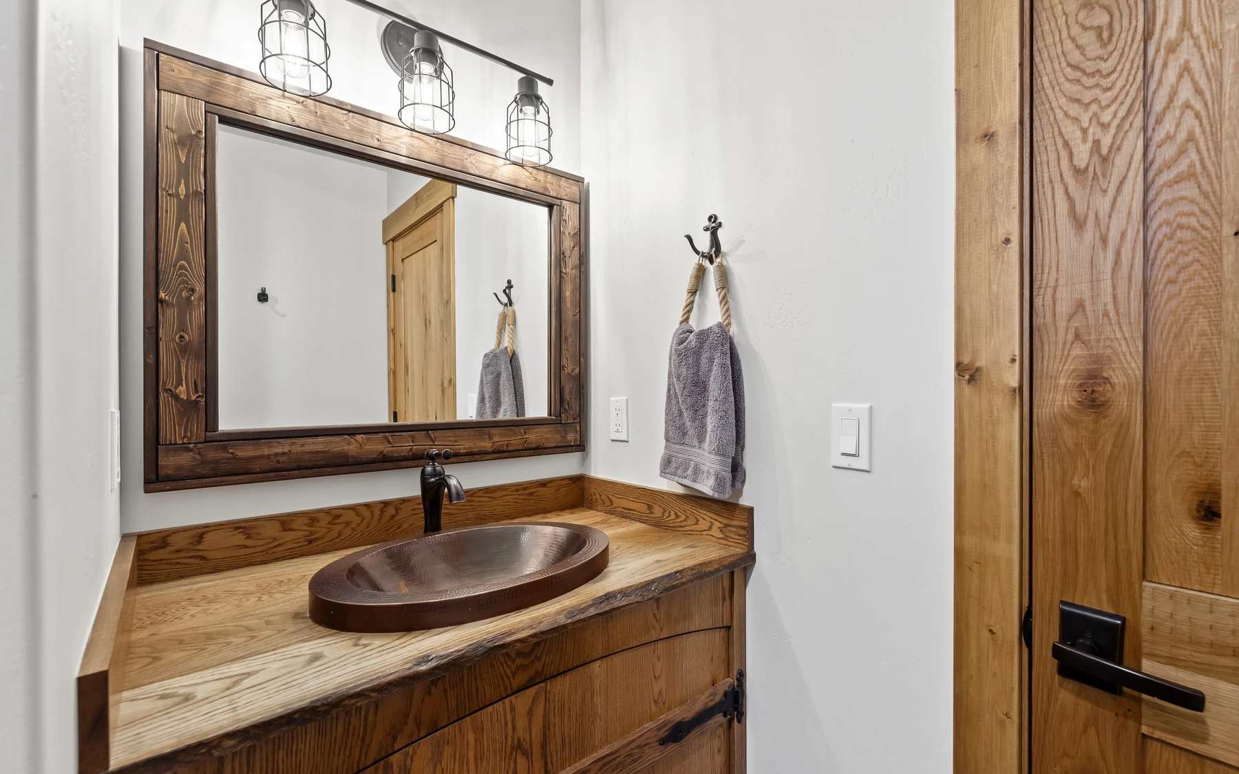 Bathroom in the Plymouth Retreat mountain home near McCall, with a custom vanity and wood cabinetry.