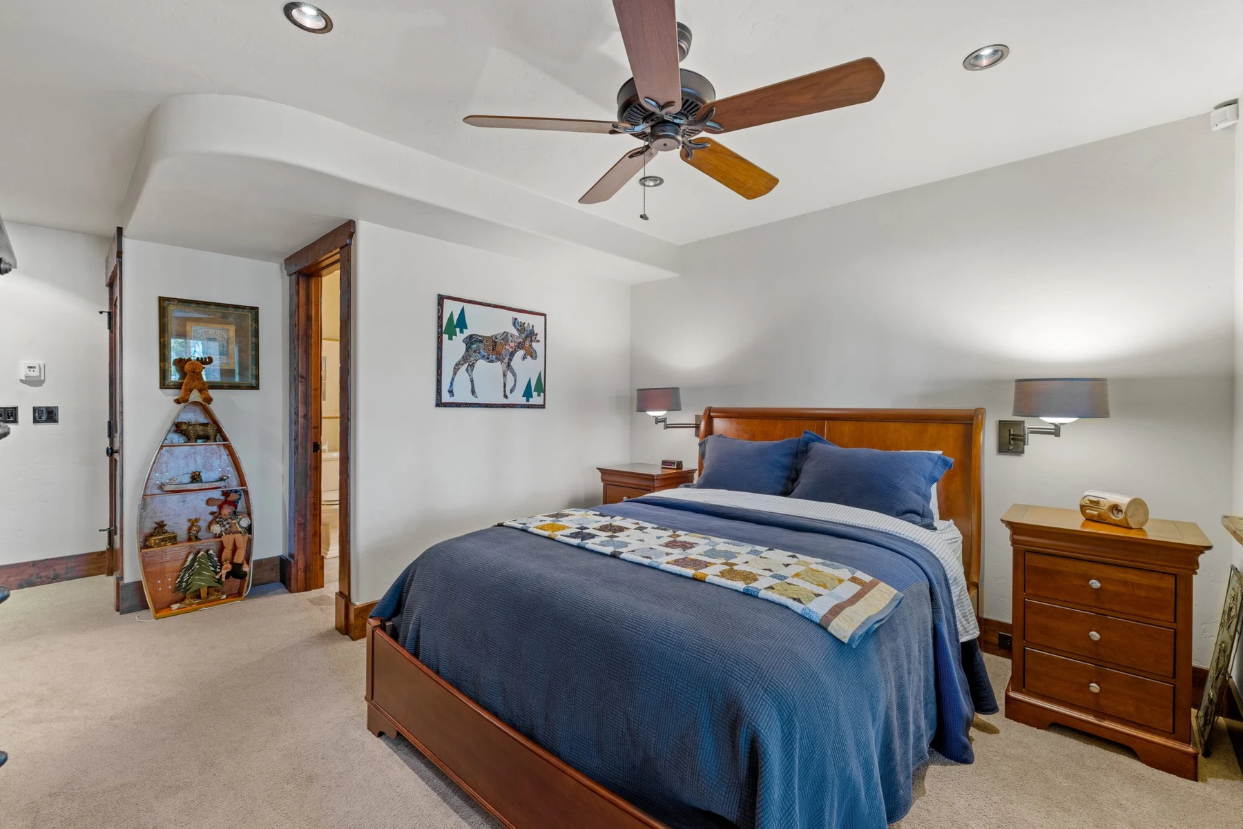 Bedroom in the Rocky Shore lakefront home on Payette Lake, with a layered bed and wood details.